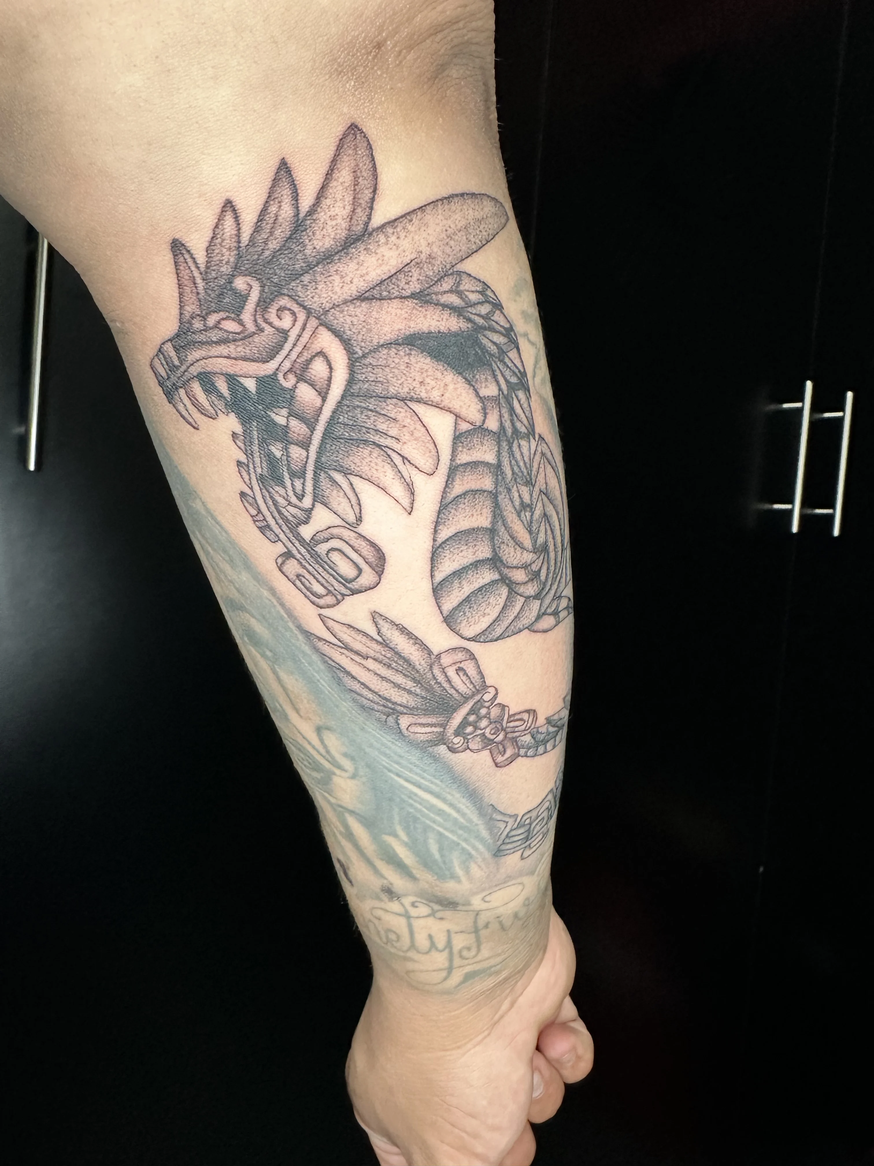 Blackwork tattoo by Krybaby: feathered serpent, dragon head, snake, mythology