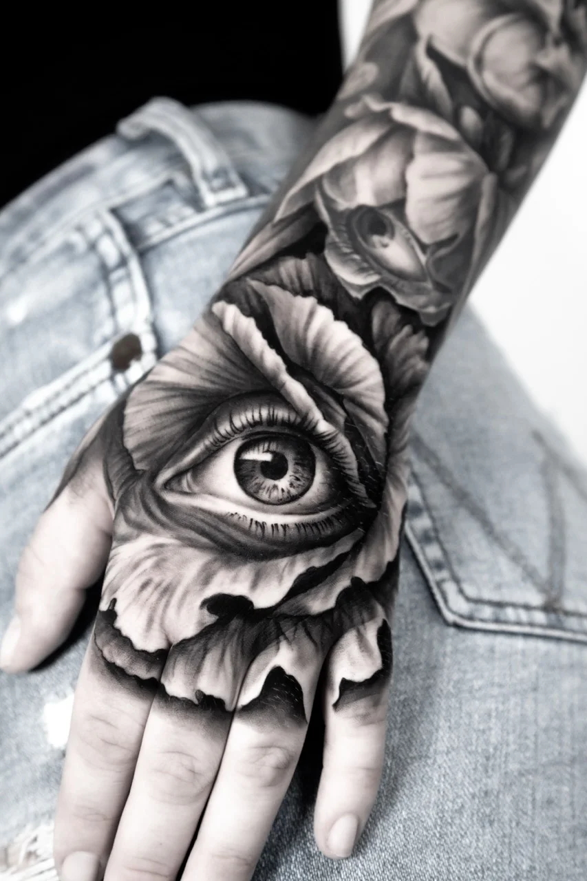 Black & Gray Realism tattoo by Ivan Cavassana: flower, eye, realism, hand tattoo