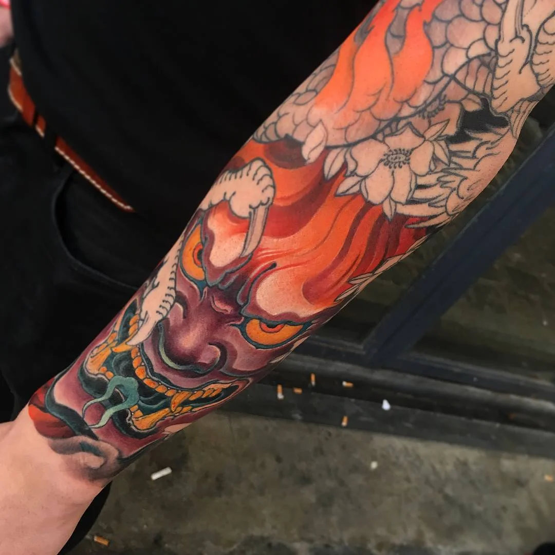 Japanese tattoo by Hocheon ART: demon mask, flames, flowers, mythology