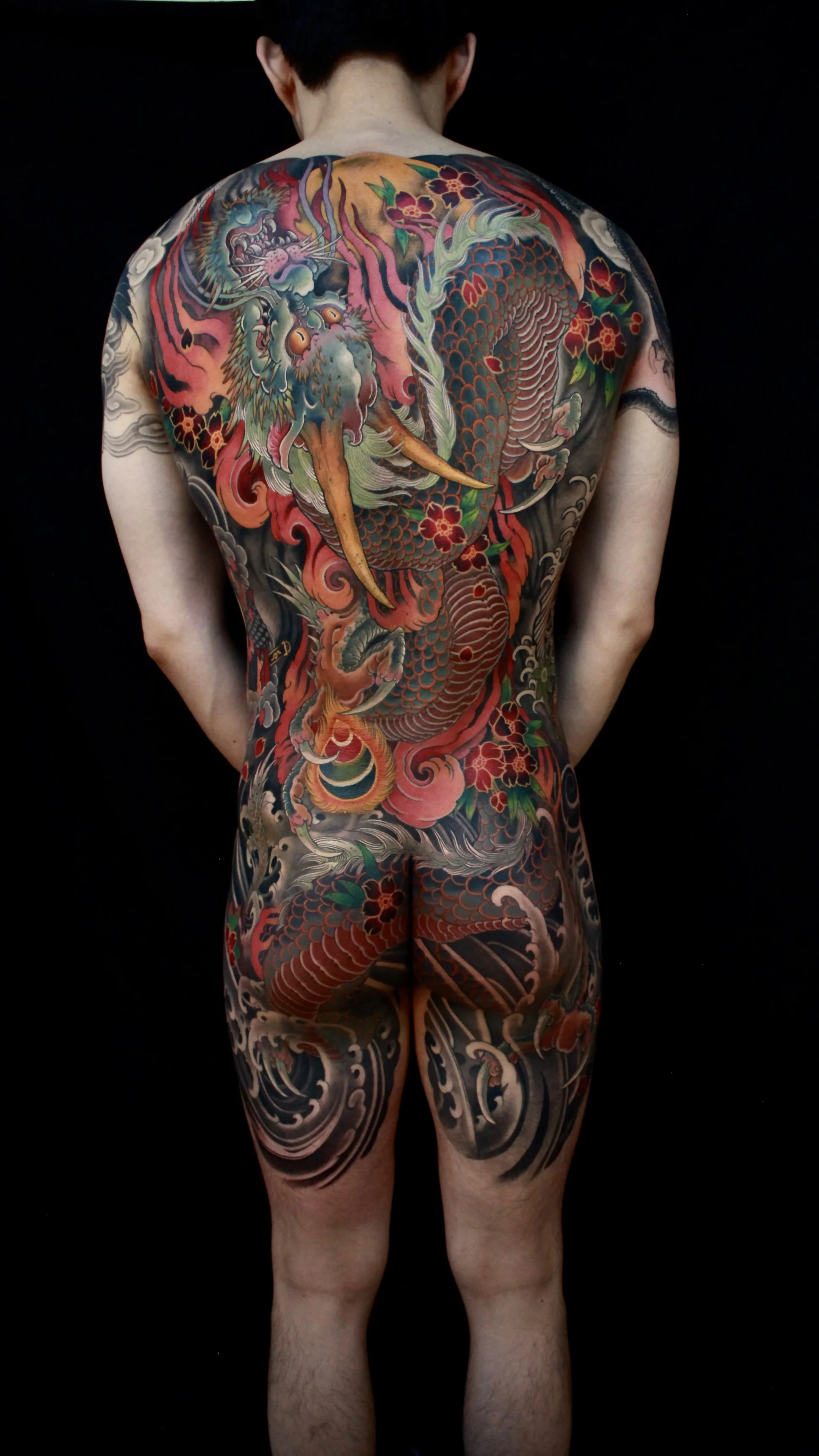 Japanese tattoo by Hocheon ART: dragon, flowers, scales, waves