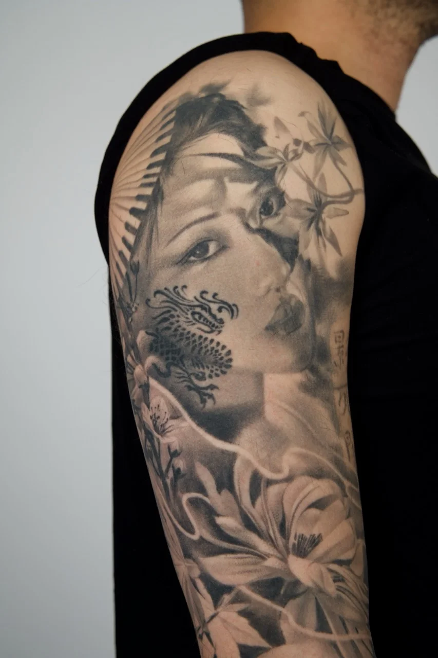 Black & Gray Realism tattoo by Gabriella Nova: woman, dragon, flowers, bamboo leaves