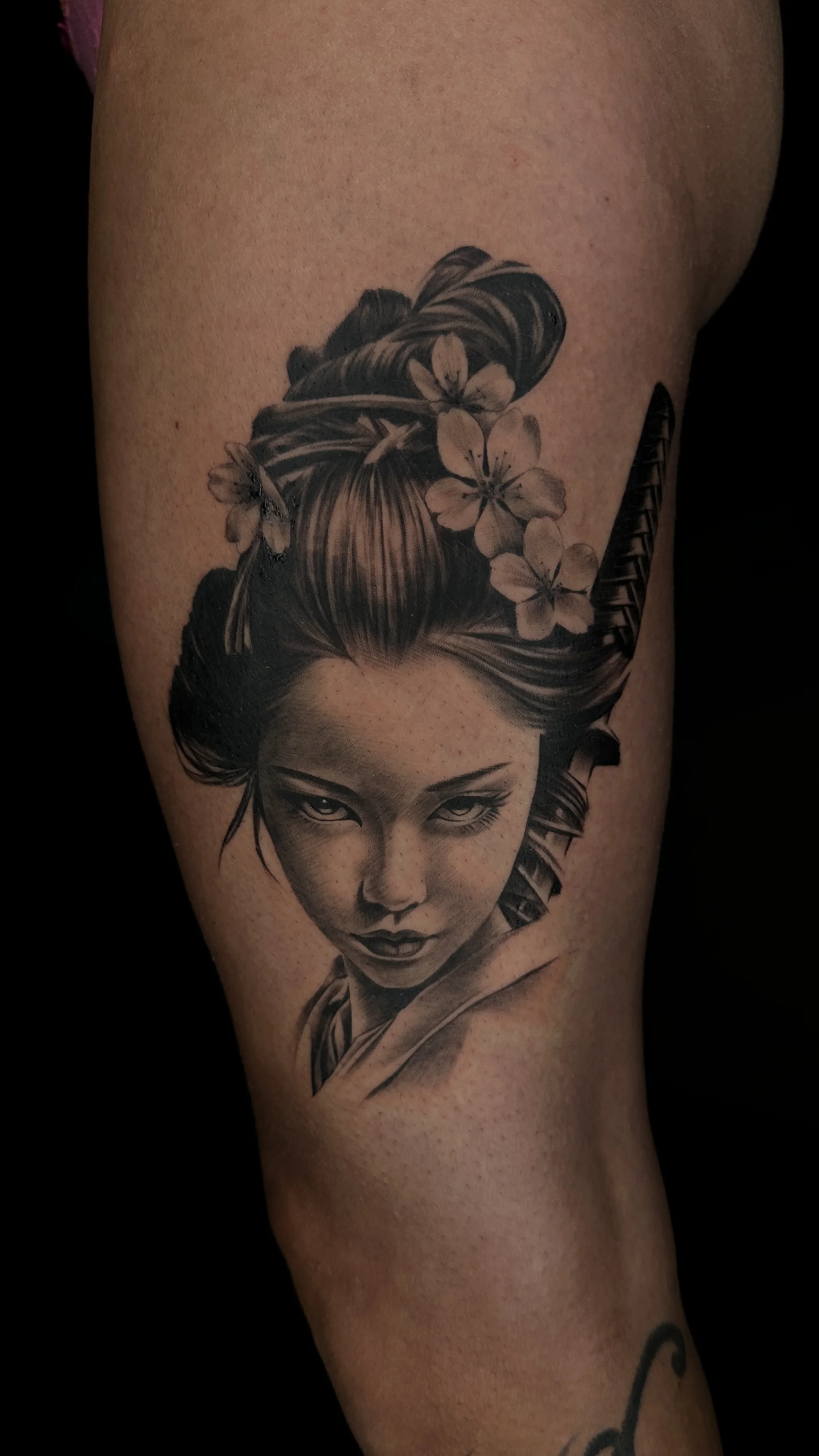 Black & Gray Realism tattoo by Gabriella Nova: woman, katana, cherry blossoms, hair bun