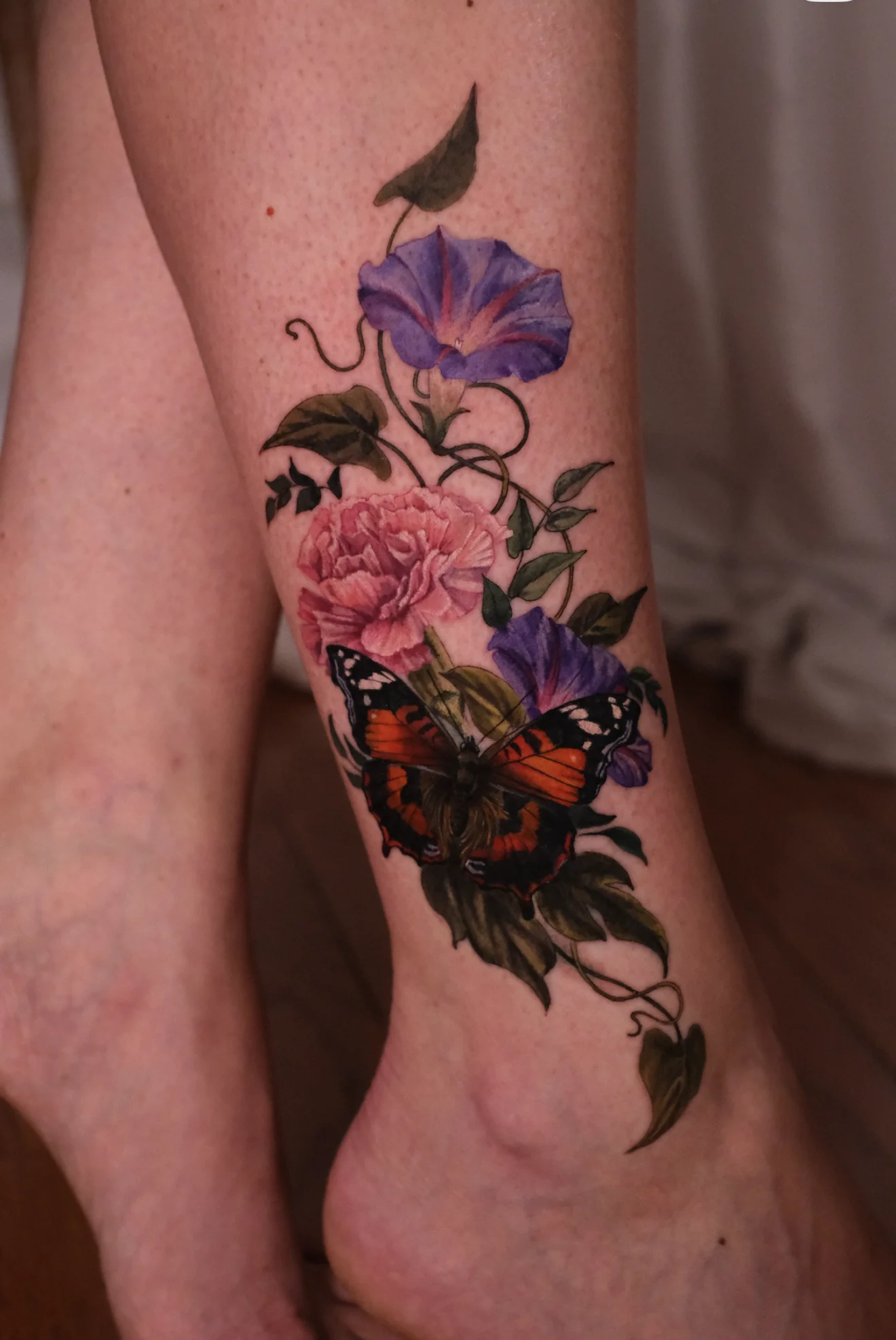 Color Realism tattoo by Valeriatattooing: morning glory flower, carnation flower, butterfly, leaves