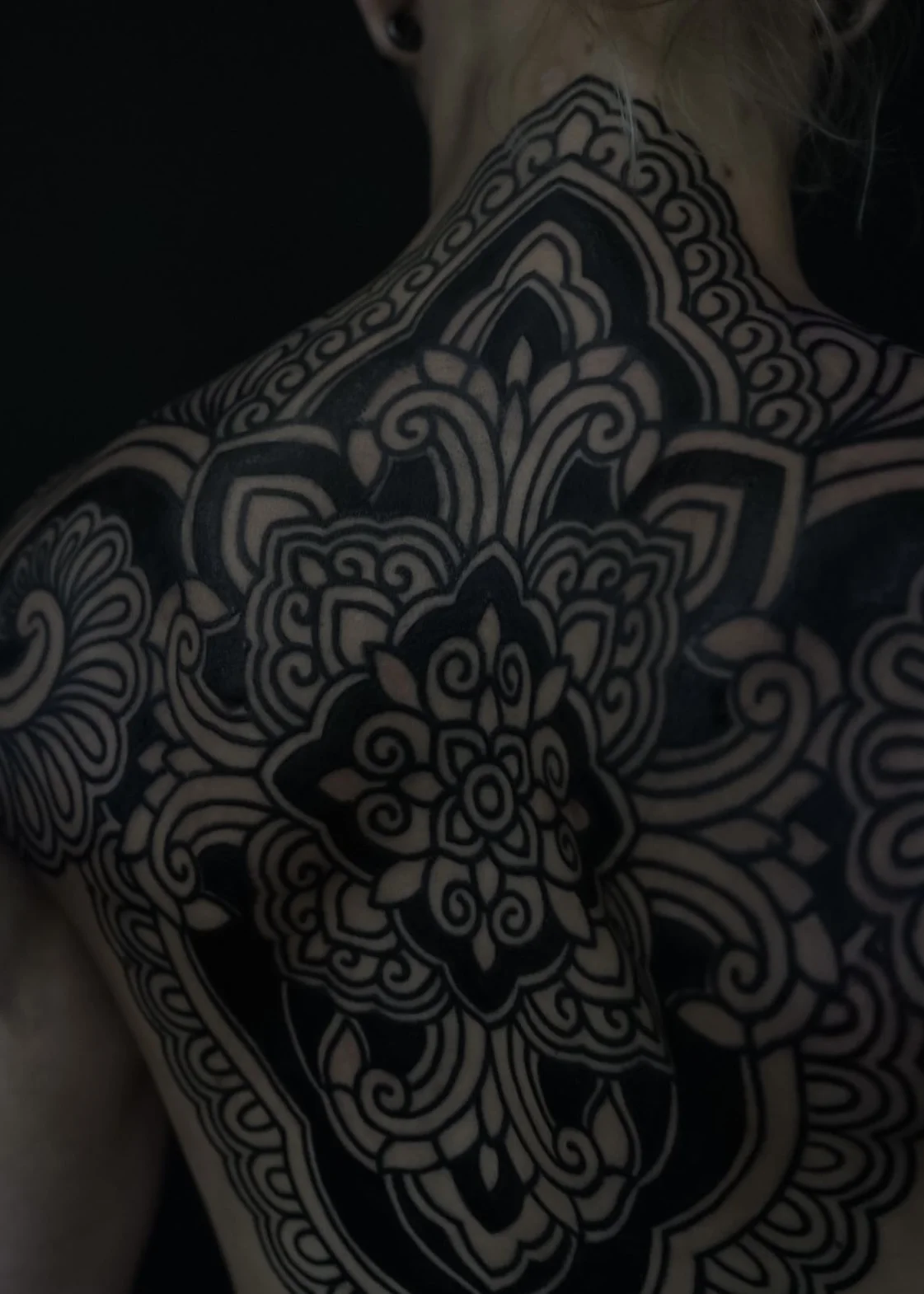 Blackwork tattoo by Oliver Kenton: mandala, floral pattern, ornamental design, geometric shapes