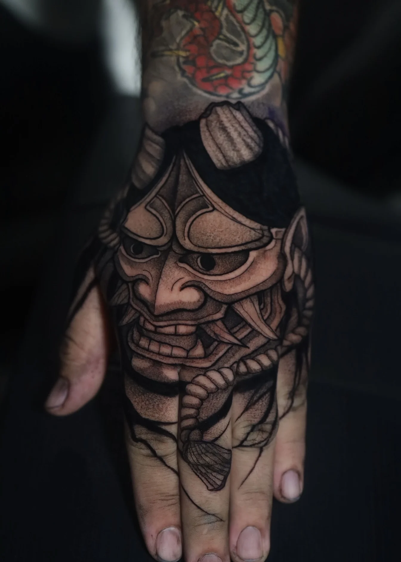 Japanese tattoo by Dana Nicole: hand tattoo, japanese, oni mask, blackwork