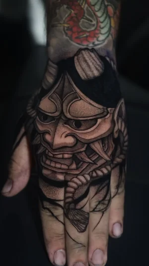 Oni mask hand tattoo