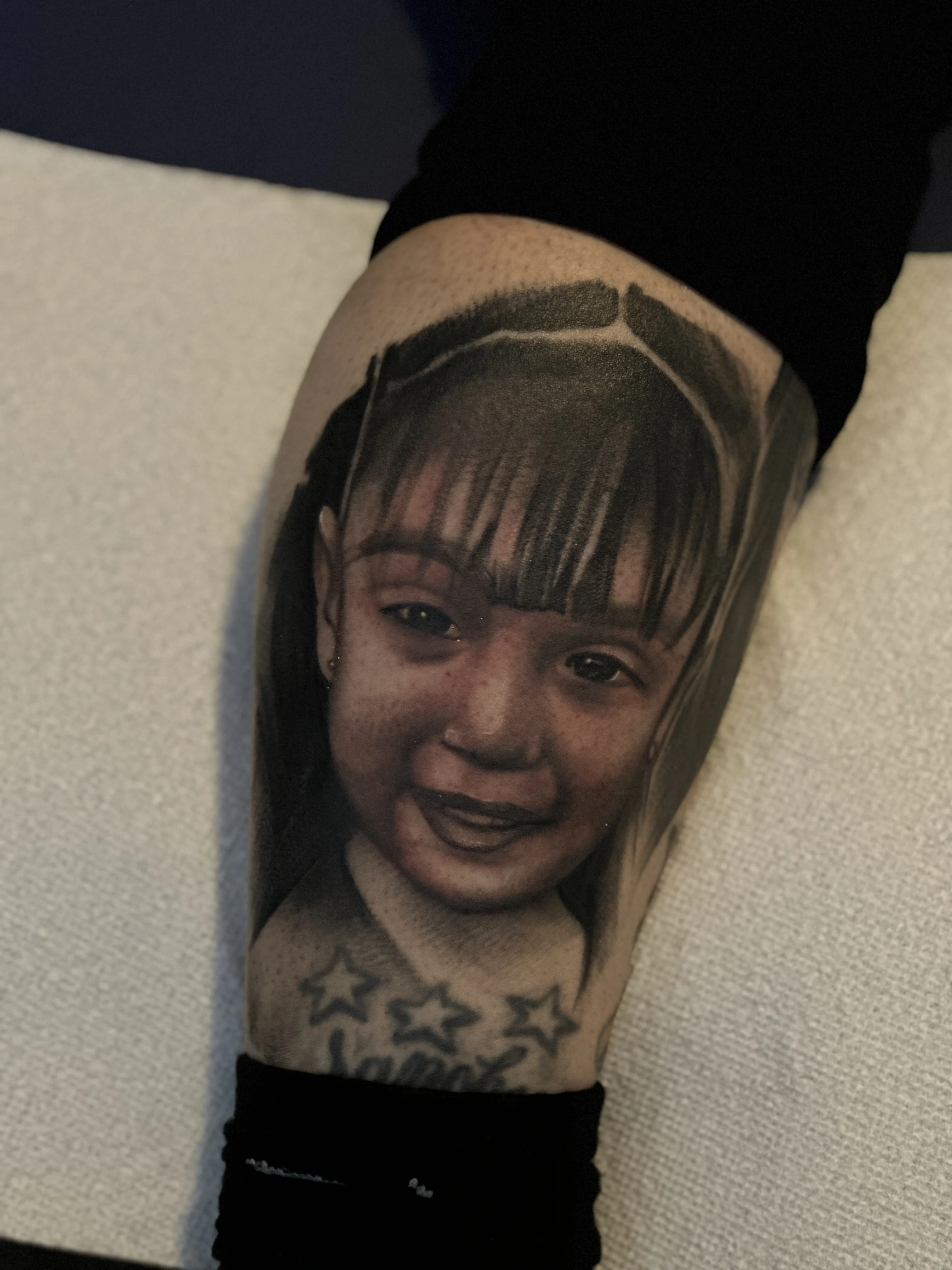 Black & Gray Realism tattoo by EL TAKAS: child's face, portrait, stars, memorial