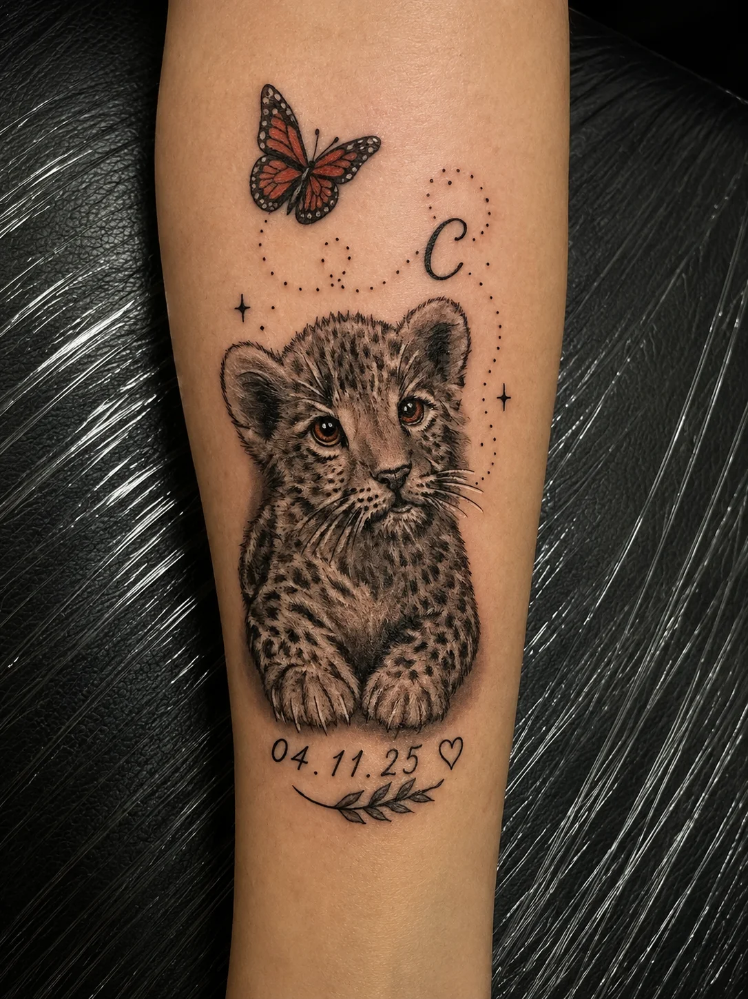Black & Gray Realism tattoo by Andrei Ilin: lion cub, butterfly, heart, leaf