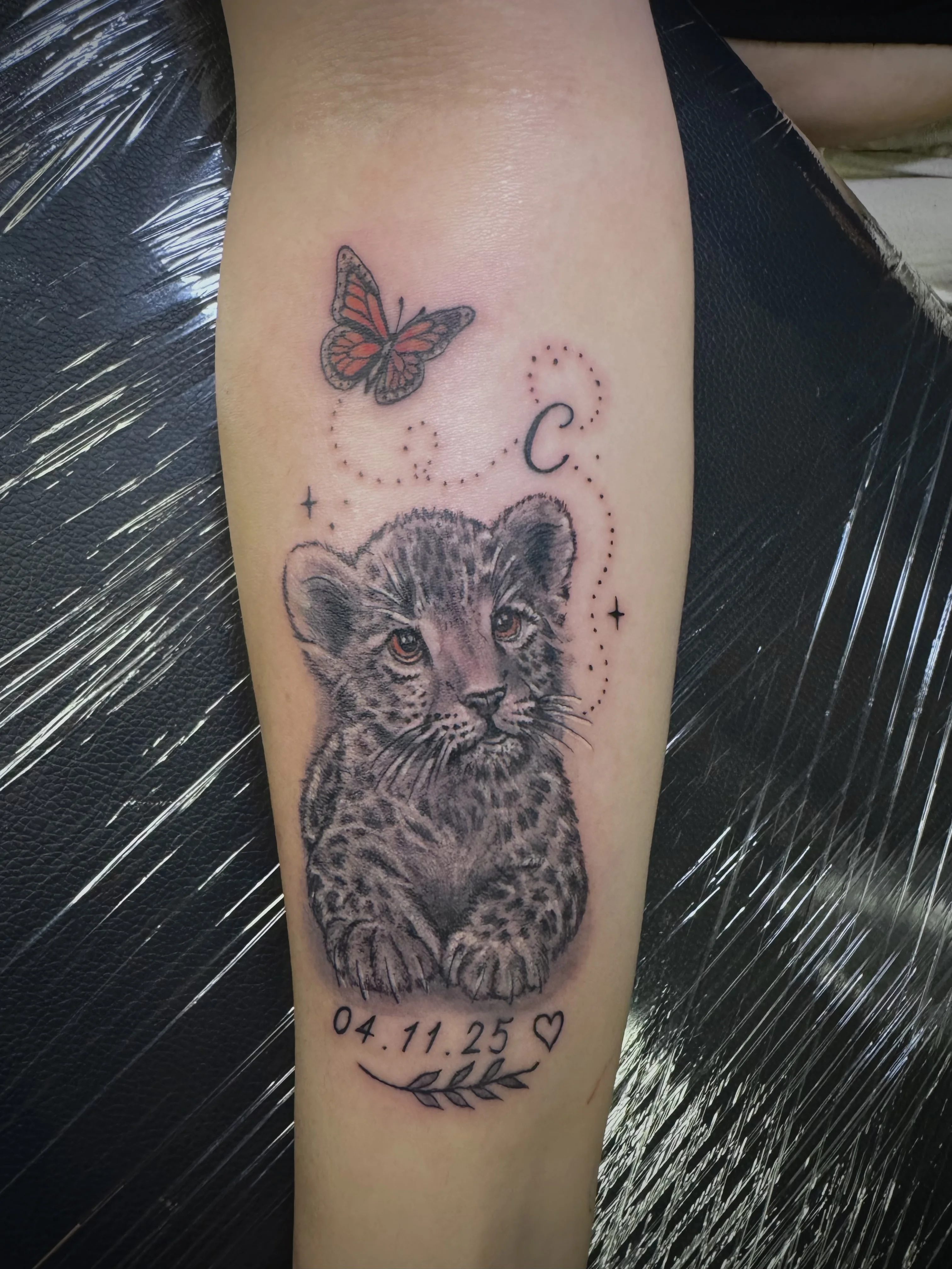 Black & Gray Realism tattoo by Andrei Ilin: lion cub, butterfly, leaf, heart