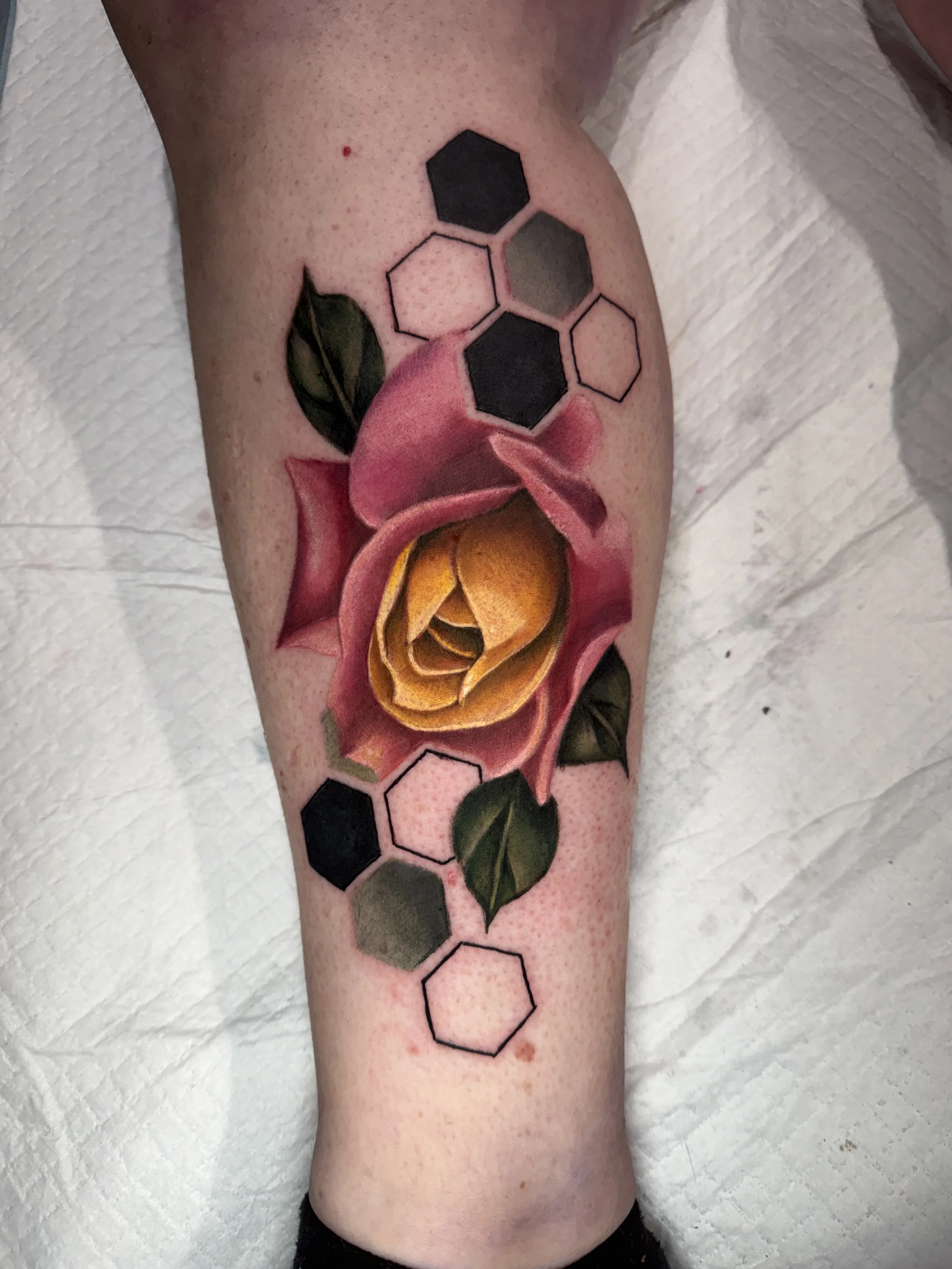 Color Realism tattoo by Crystal Alexandria: rose, leaves, hexagons, floral