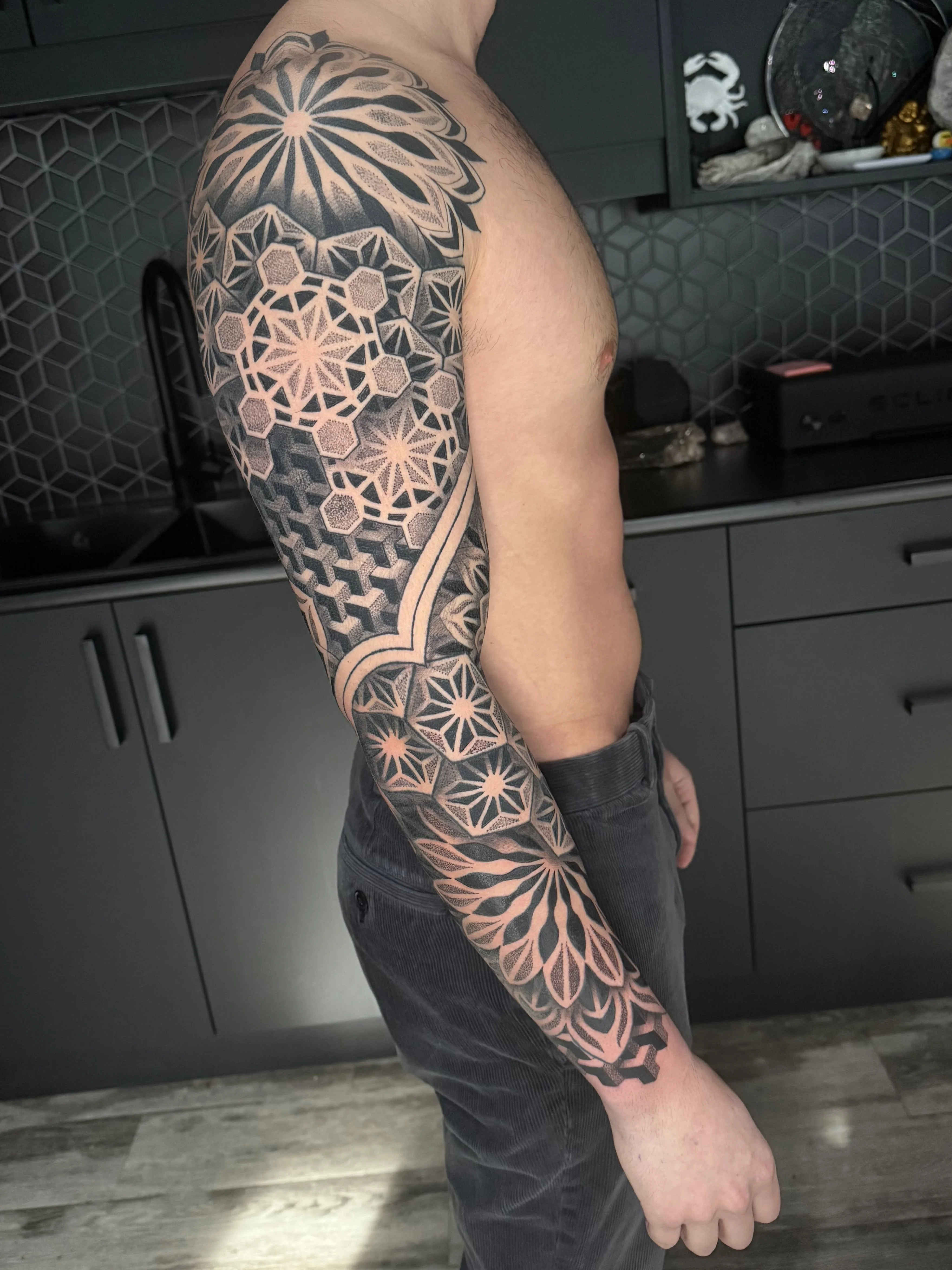 Geometric tattoo by Crystal Alexandria: geometric shapes, hexagons, stars, flower pattern