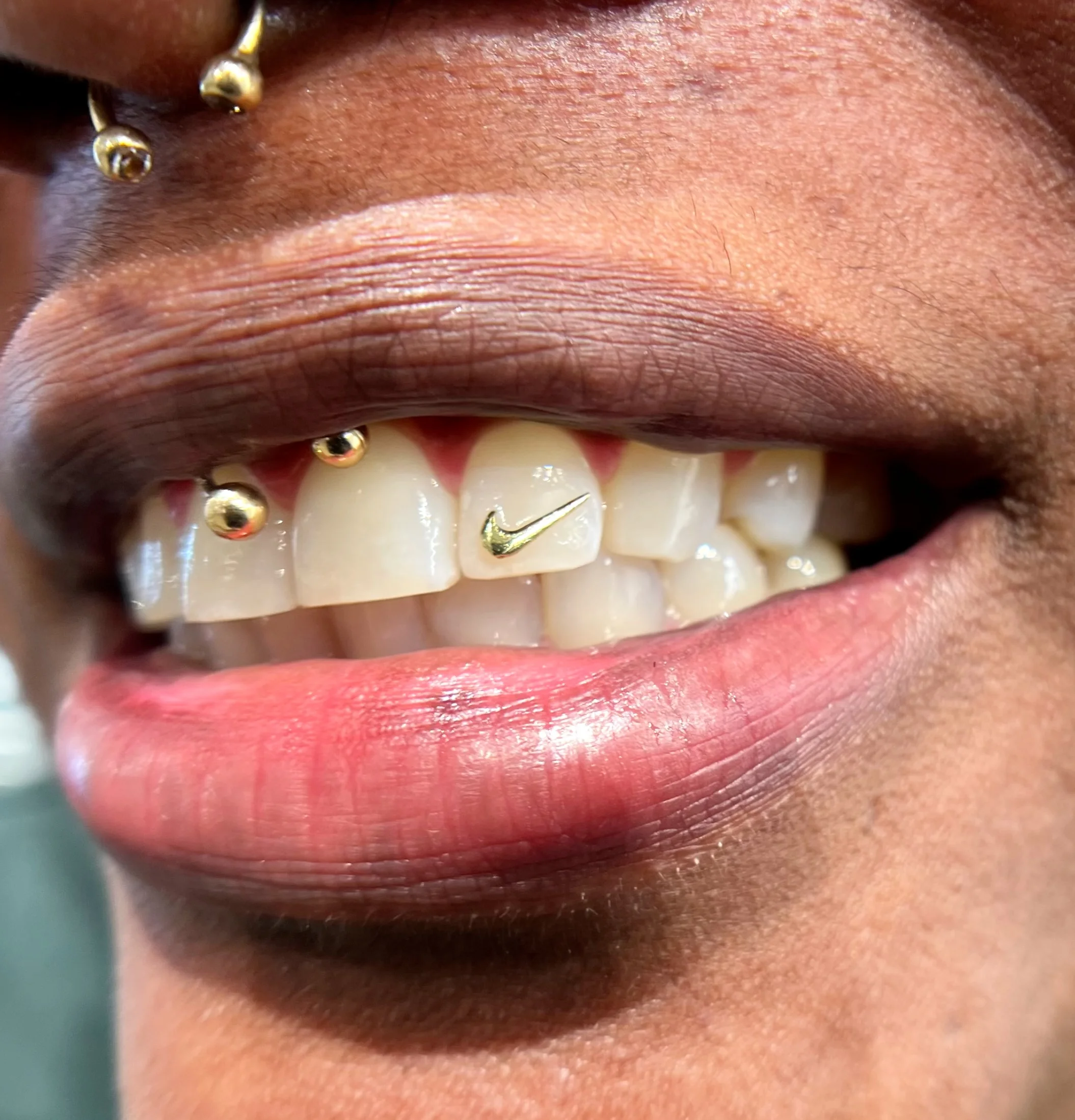 Microrealism tattoo by Cherie: gold teeth jewelry, nike logo grill, fashion, body modification