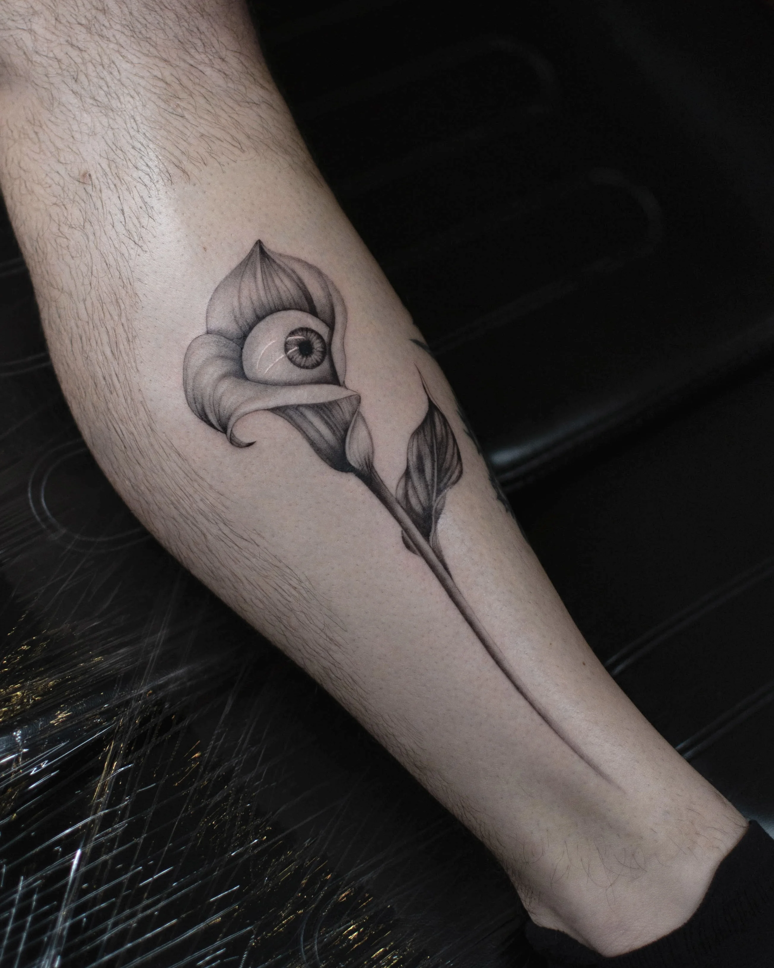 Black & Gray Realism tattoo by Vira.Ink: flower, eye, leaf, stem