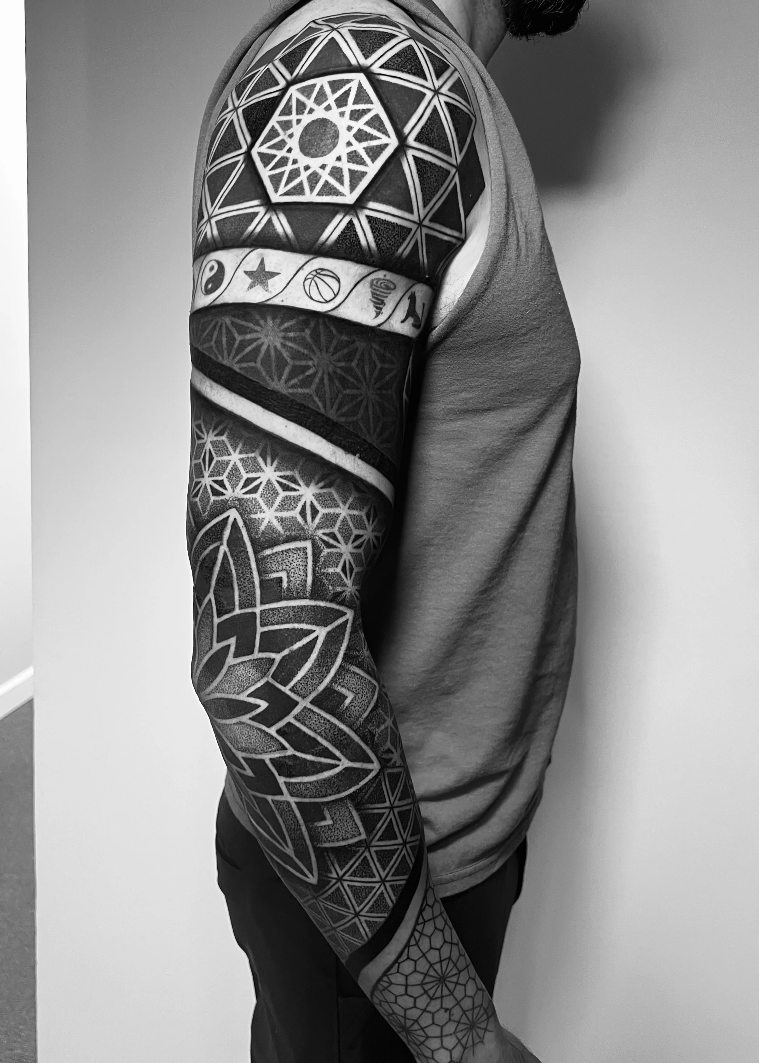 Geometric tattoo by Erin Manning: star, basketball, yin yang, spiral