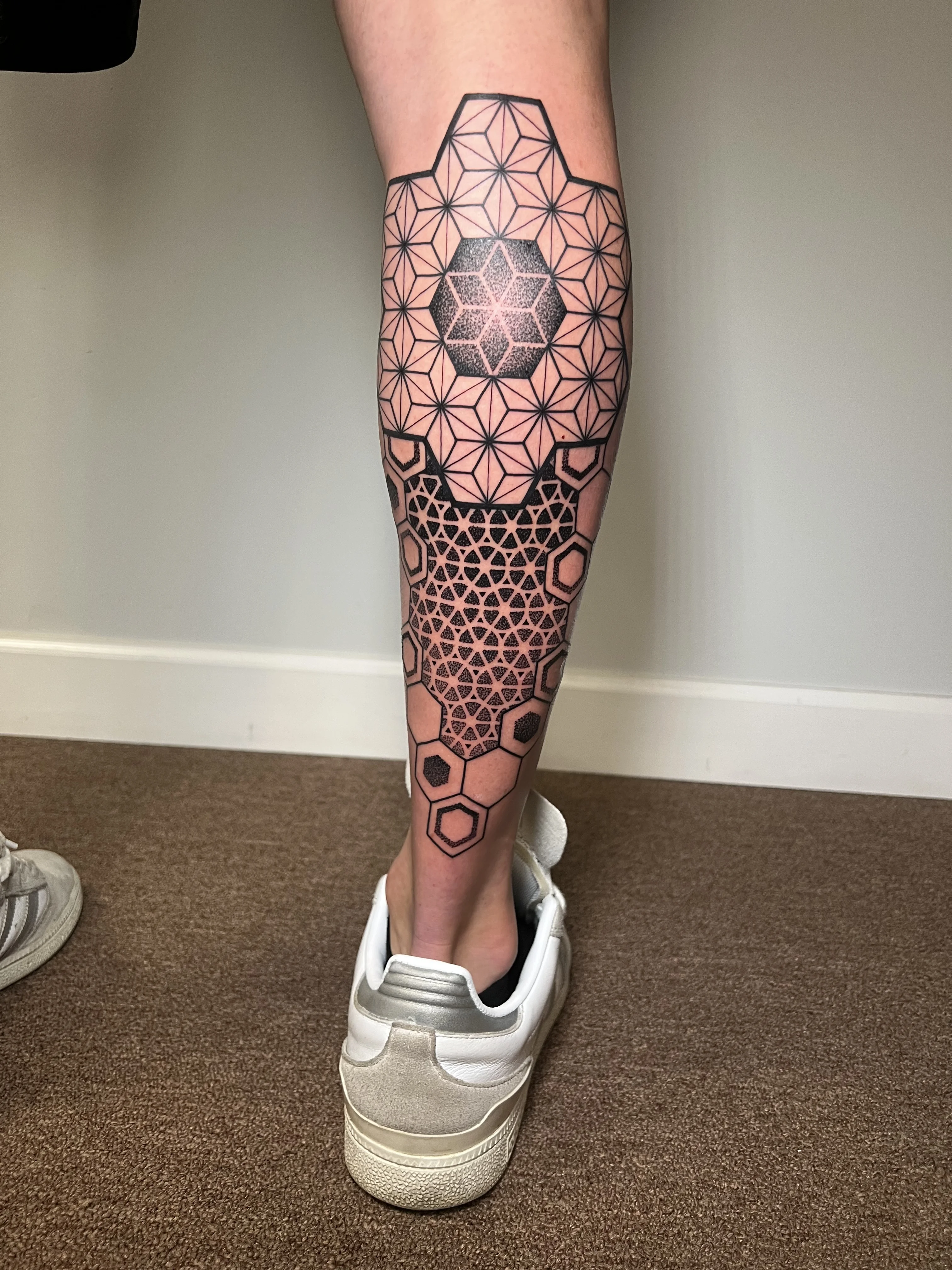 Geometric tattoo by Erin Manning: hexagons, triangles, lines, dots