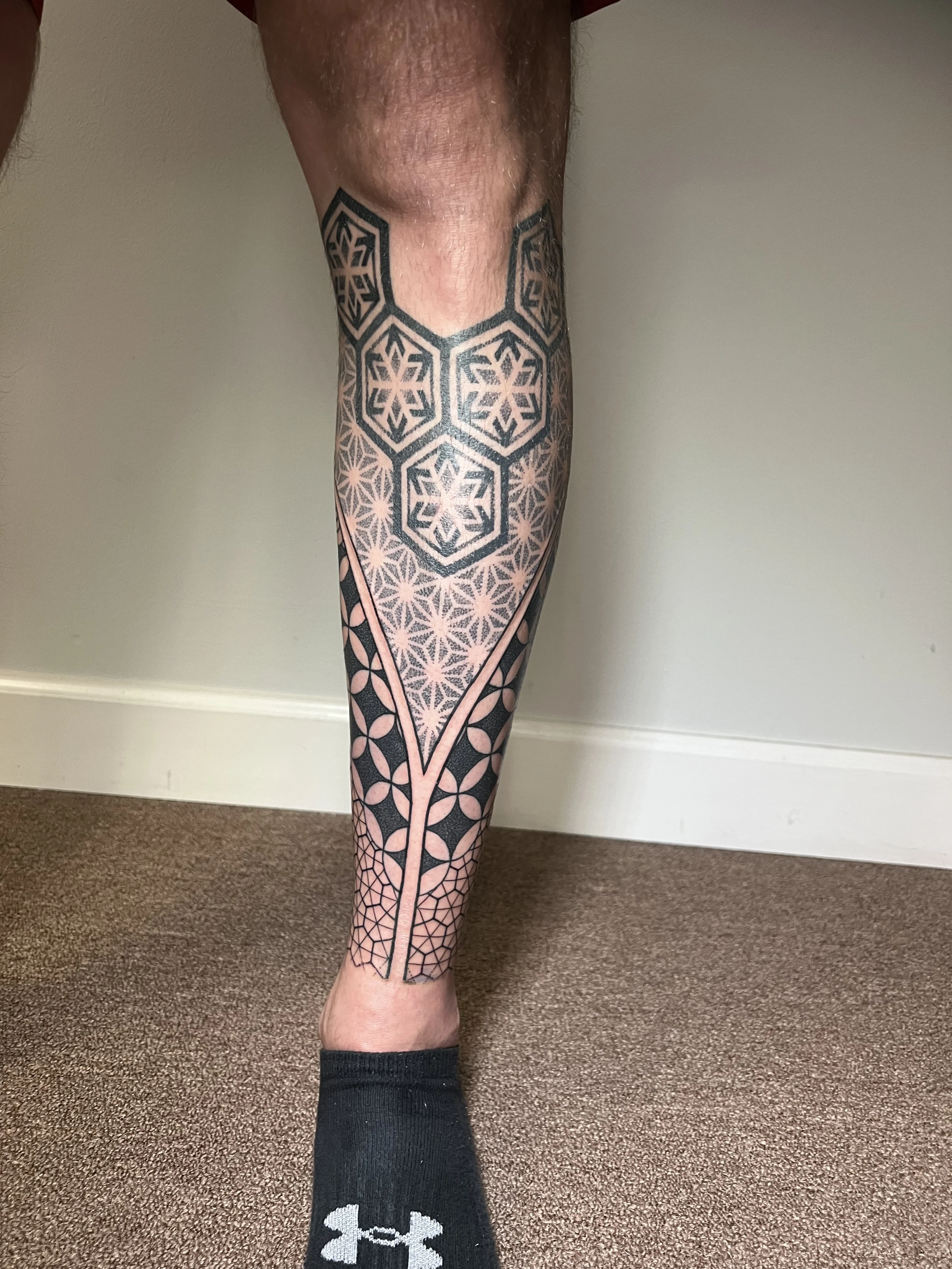 Geometric tattoo by Erin Manning: hexagons, stars, flower of life pattern, geometric shapes
