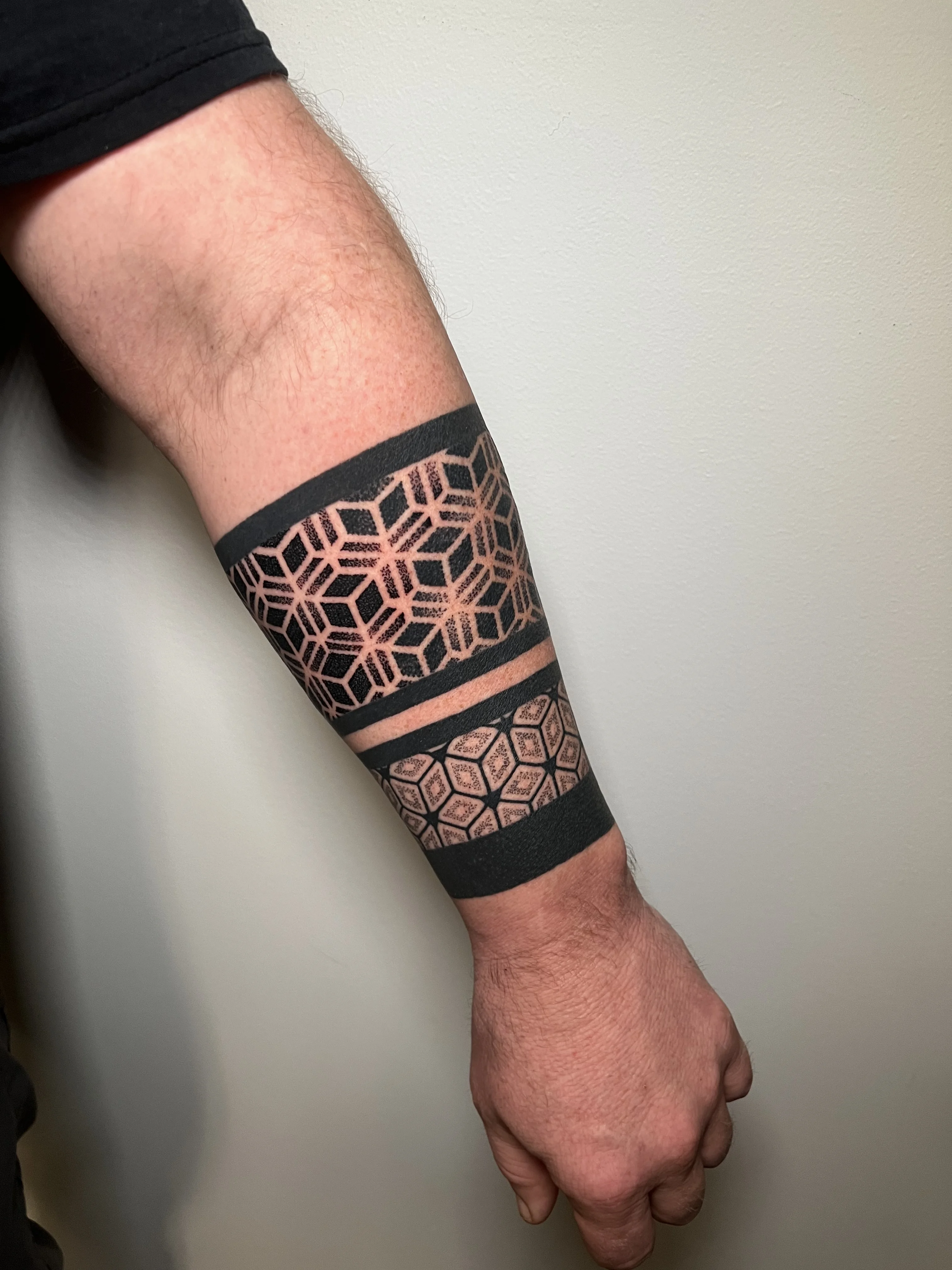 Blackwork tattoo by Erin Manning: geometric pattern, hexagons, lines, shapes