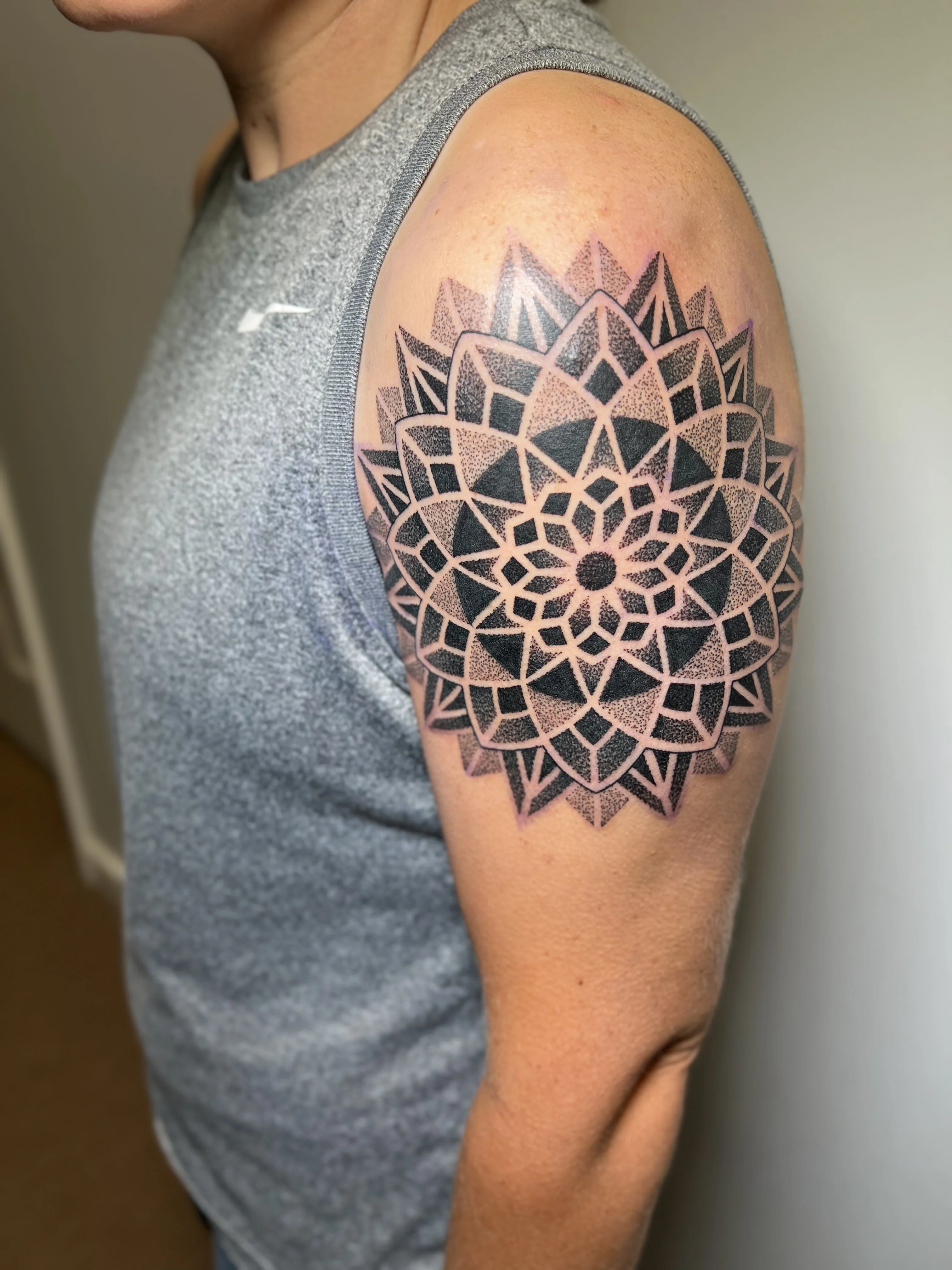 Blackwork tattoo by Erin Manning: mandala, geometric pattern, flower, geometric
