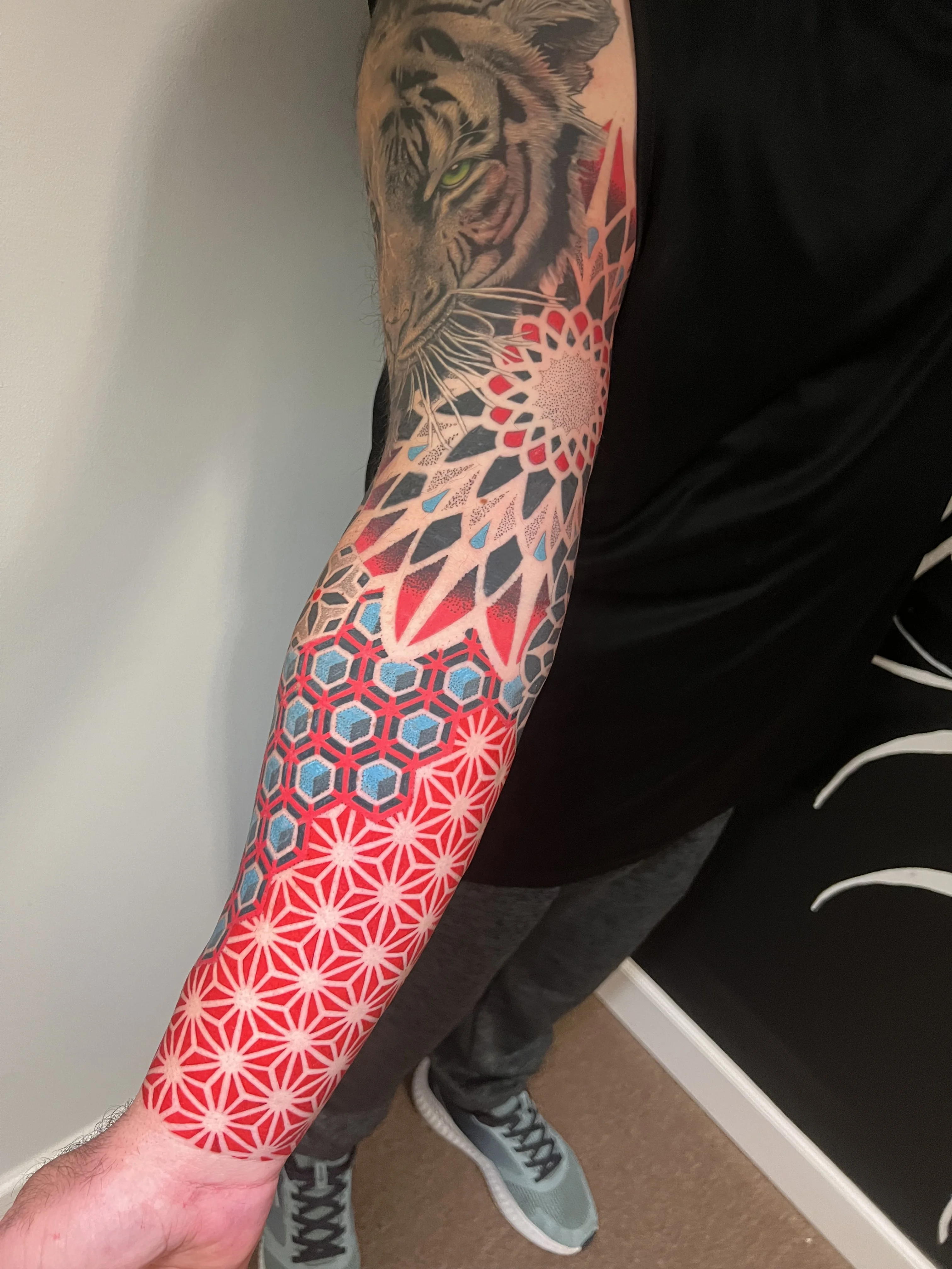 Geometric tattoo by Erin Manning: tiger, geometric pattern, hexagons, flower