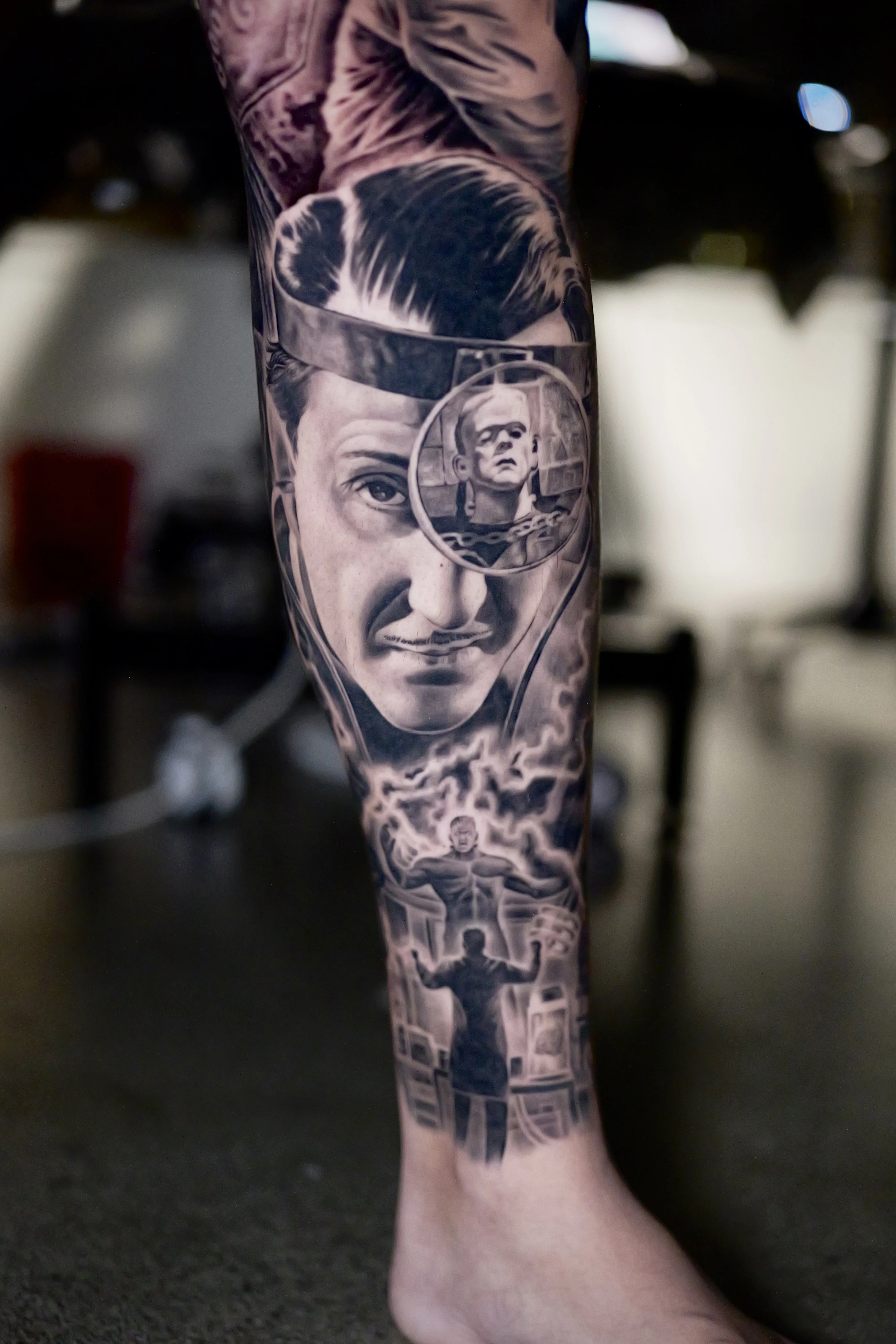 Black & Gray Realism tattoo by Ezra Currier: portrait of man with mustache, portrait of frankenstein's monster, scientist figure, electricity bolts