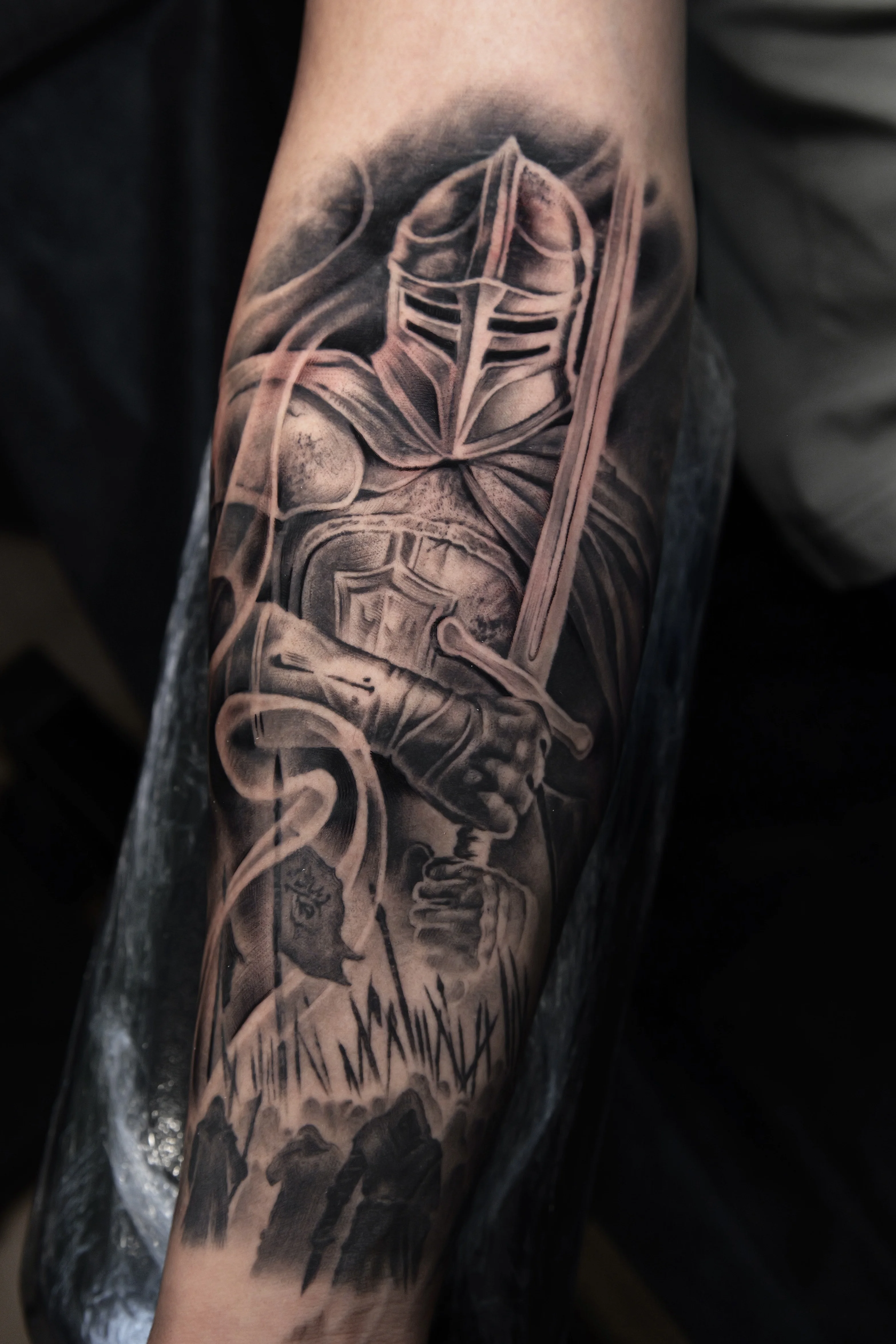 Black & Gray Realism tattoo by Ezra Currier: knight, helmet, sword, armor