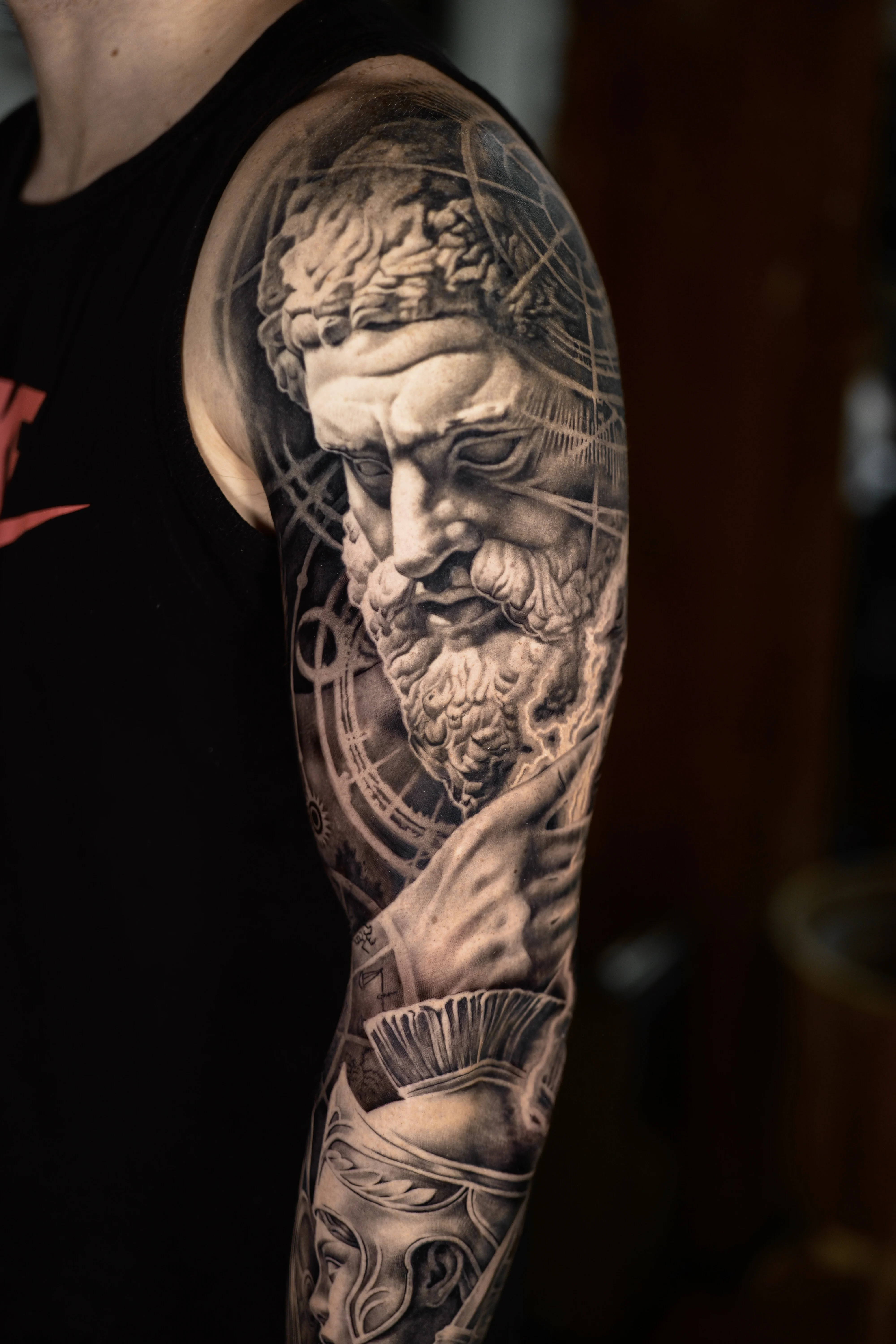 Black & Gray Realism tattoo by Ezra Currier: ancient man, beard, hand, helmet