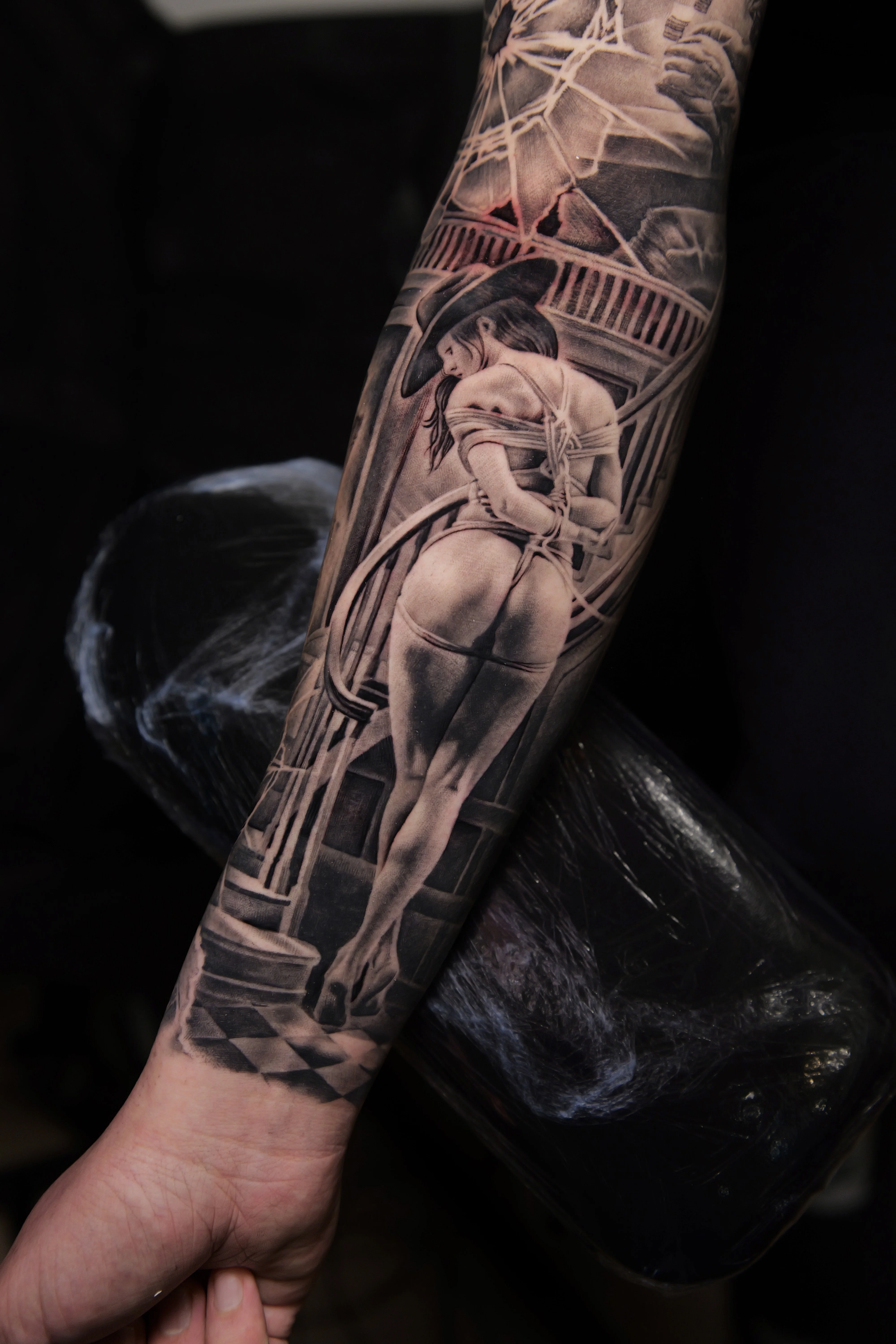 Black & Gray Realism tattoo by Ezra Currier: woman, hat, rope, archway