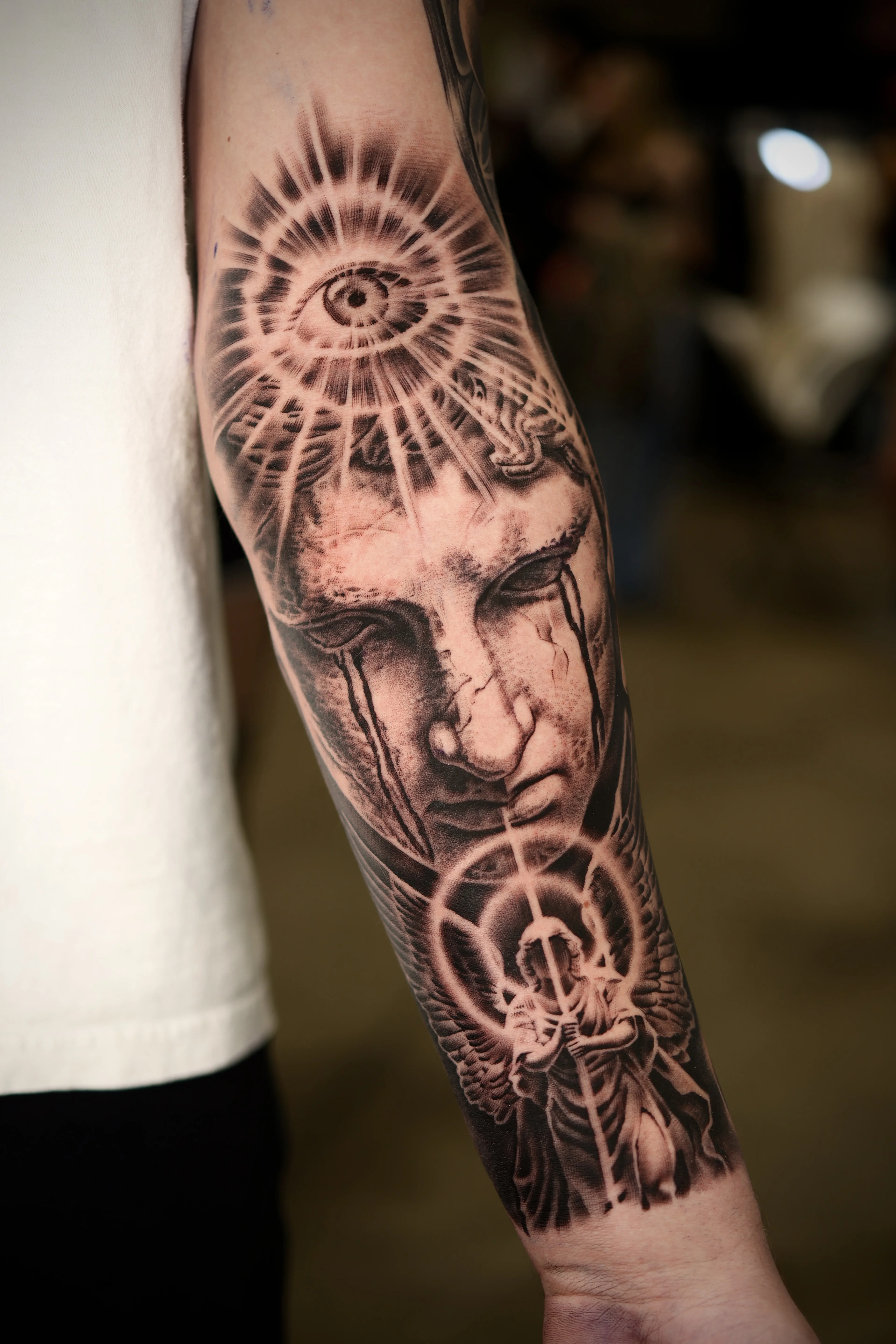Black & Gray Realism tattoo by Ezra Currier: eye, face, angel, rays of light