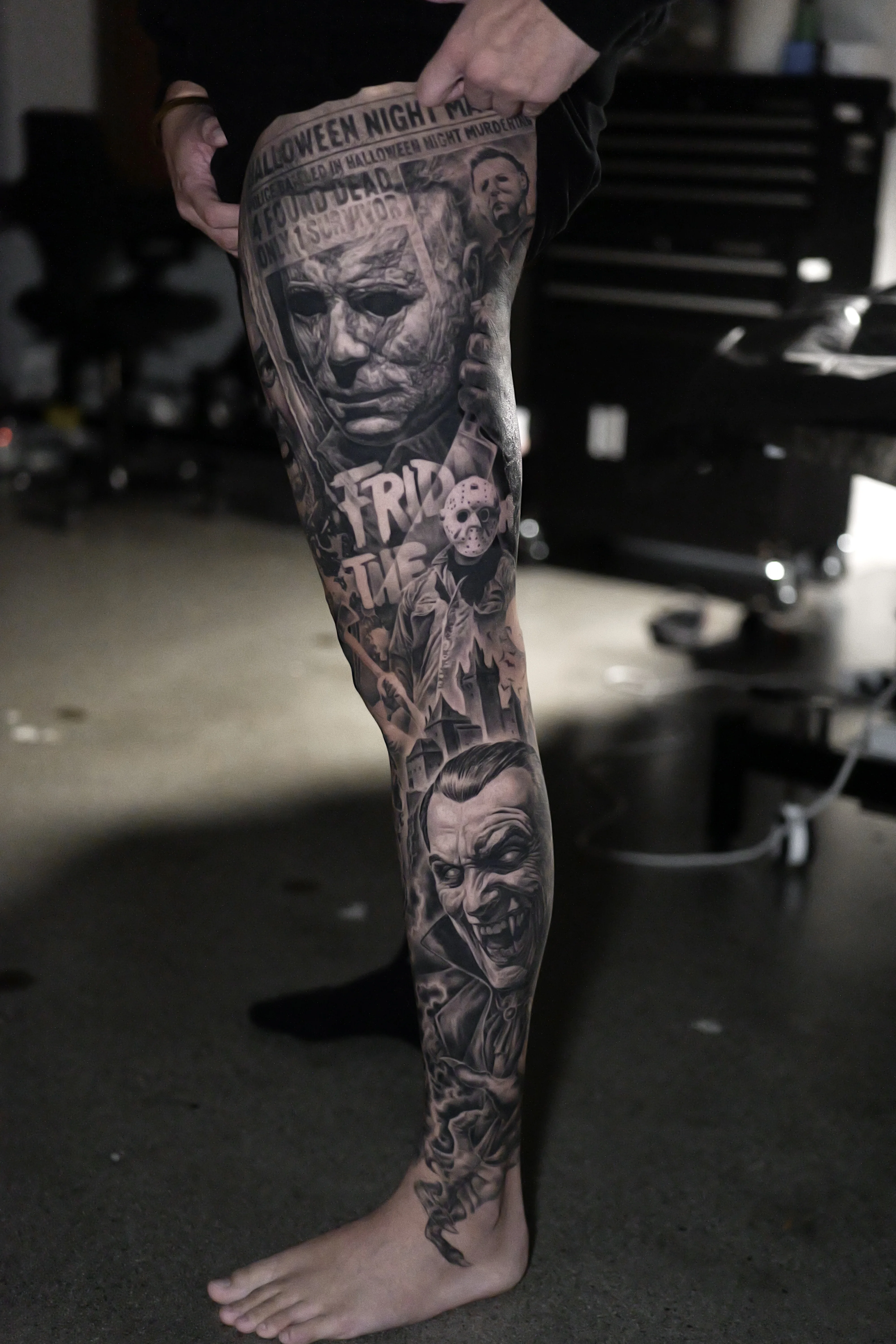 Black & Gray Realism tattoo by Ezra Currier: michael myers, jason voorhees, halloween night newspaper, friday the 13th text