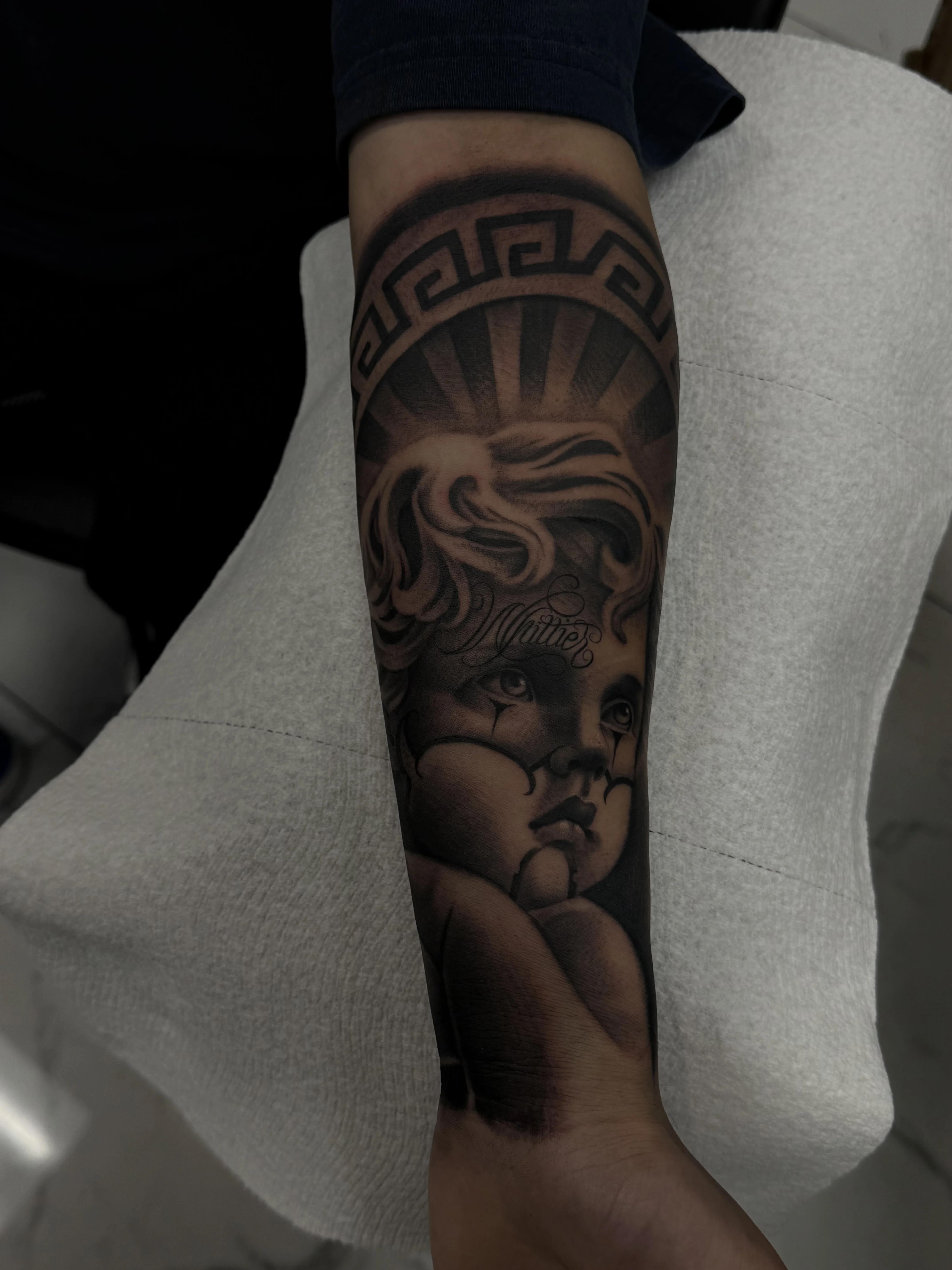 Black & Gray Realism tattoo by Toto G: angel, child, face, rays