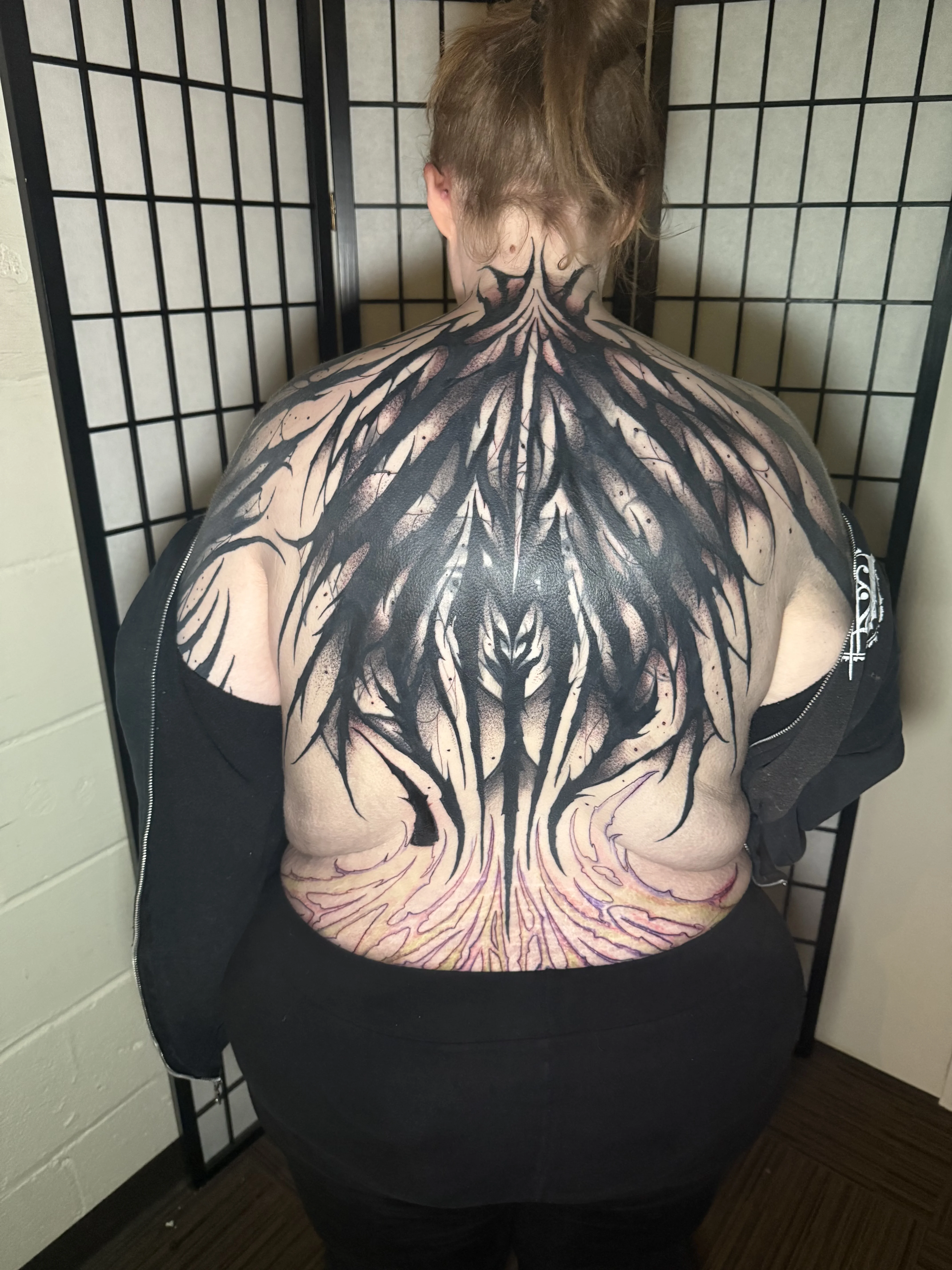Blackwork tattoo by Donnie Chapman: abstract shapes, flames, spikes, dark