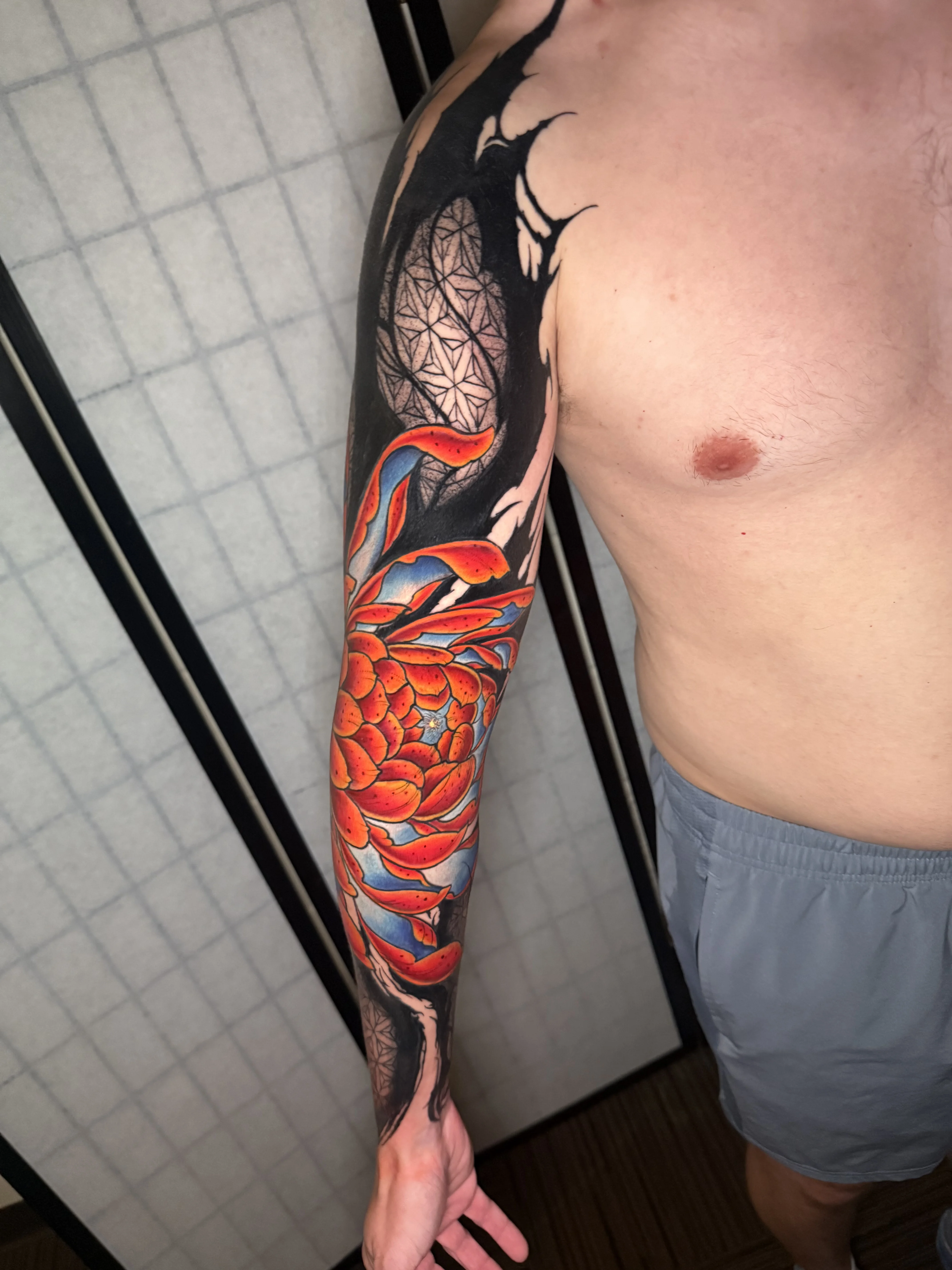 Japanese tattoo by Donnie Chapman: chrysanthemum flower, petals, negative space, floral