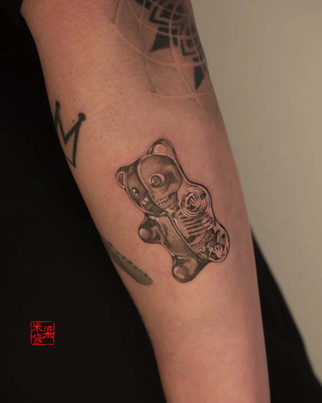 Black & Gray Realism tattoo by Michelle.tatts: gummy bear, gummy bear skeleton, half bear, surreal