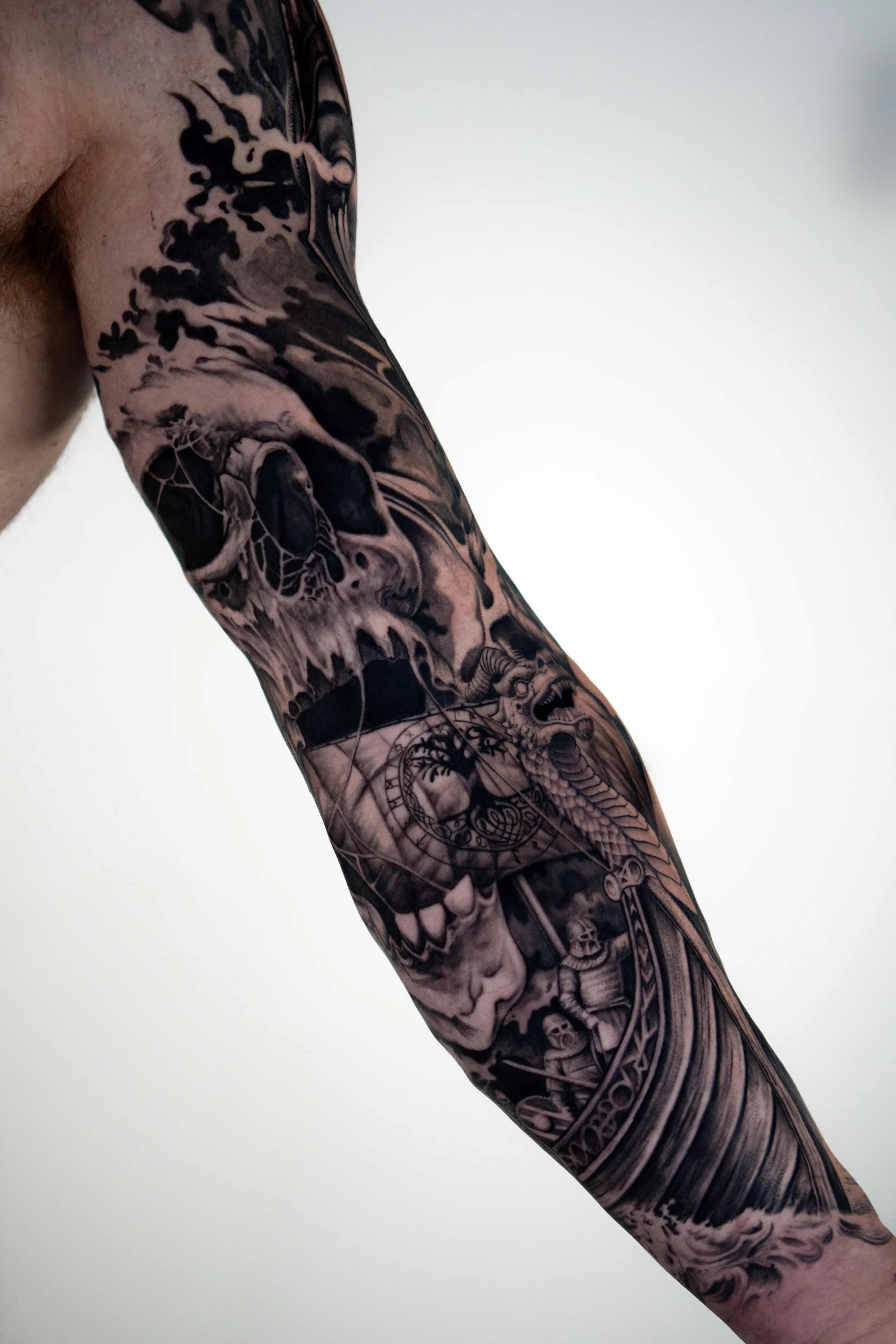 Black & Gray Realism tattoo by Do Santos: skull, snake, clock, ship