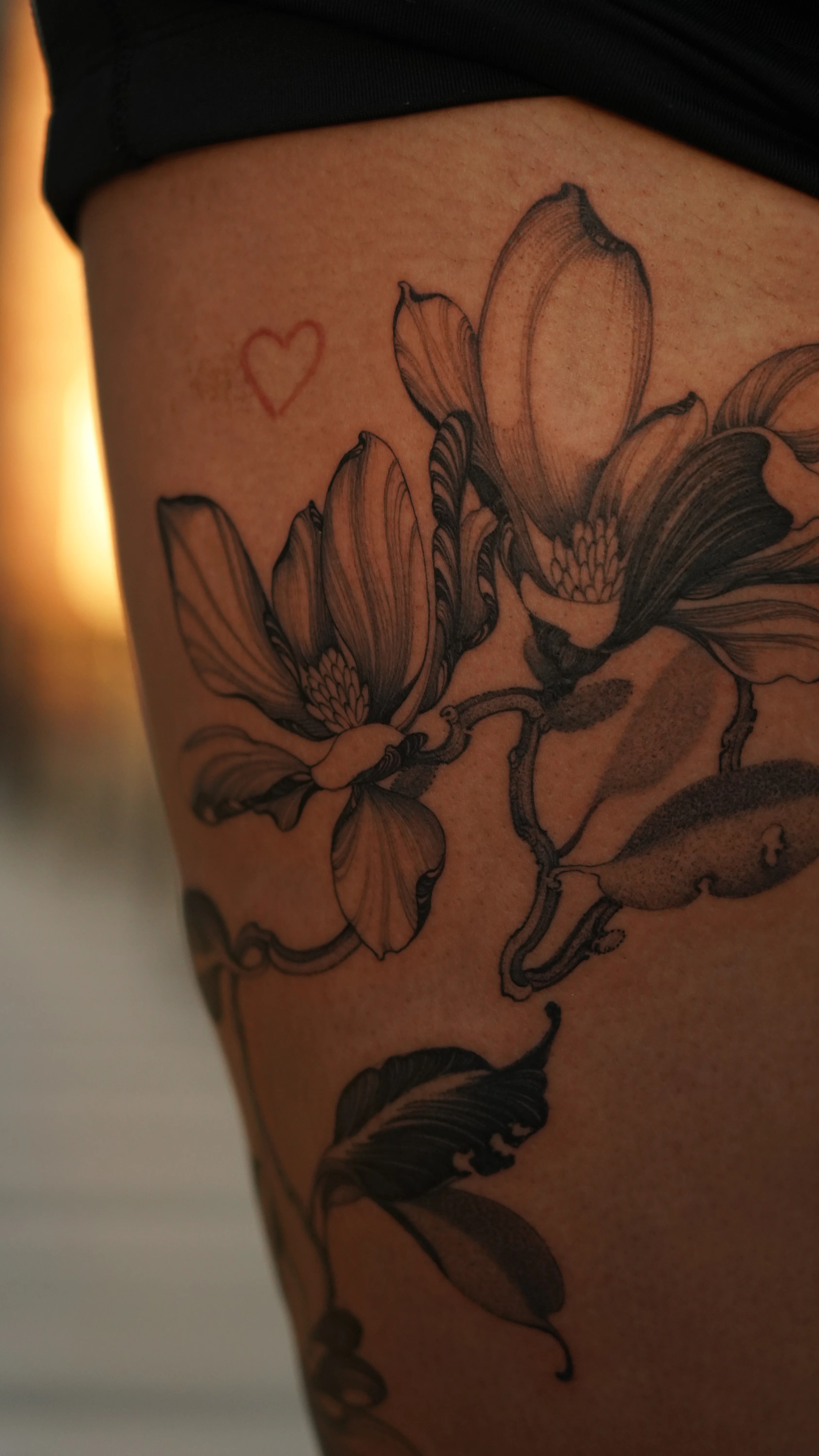 Black & Gray Realism tattoo by Sam Leng: magnolia flowers, leaves, small heart, floral