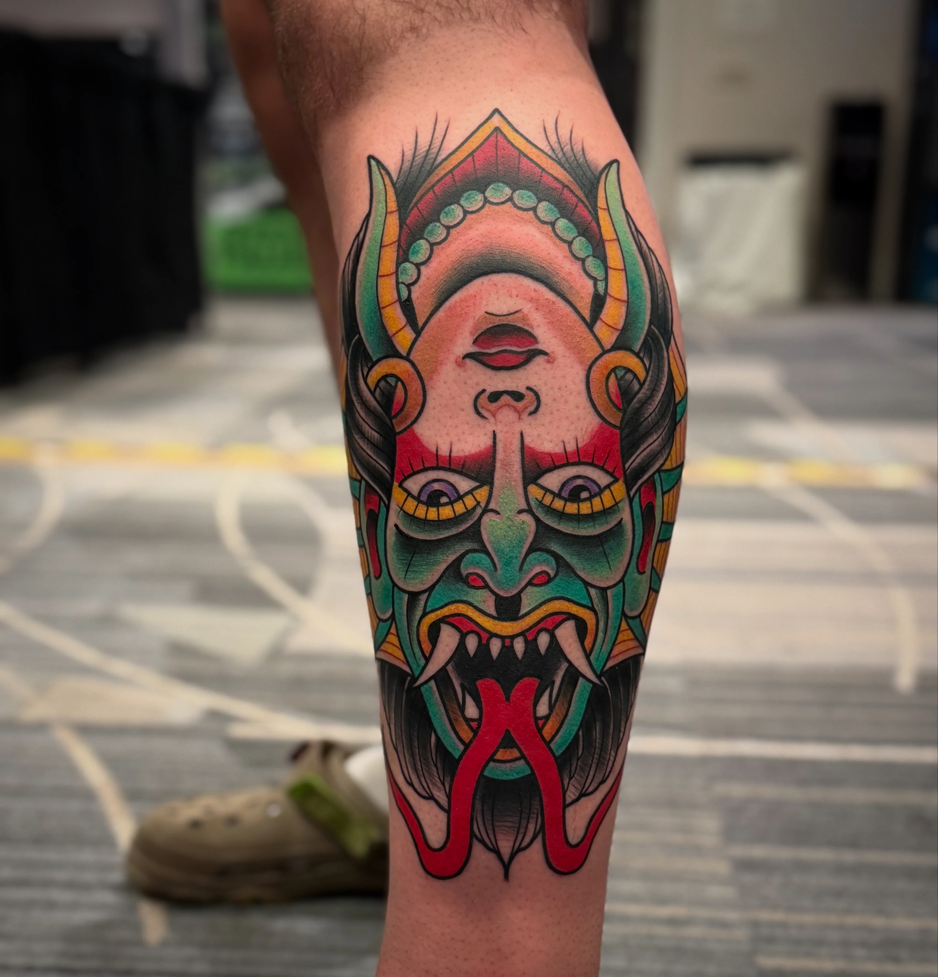 Traditional tattoo by Don Don: demon face, horns, fangs, tongue