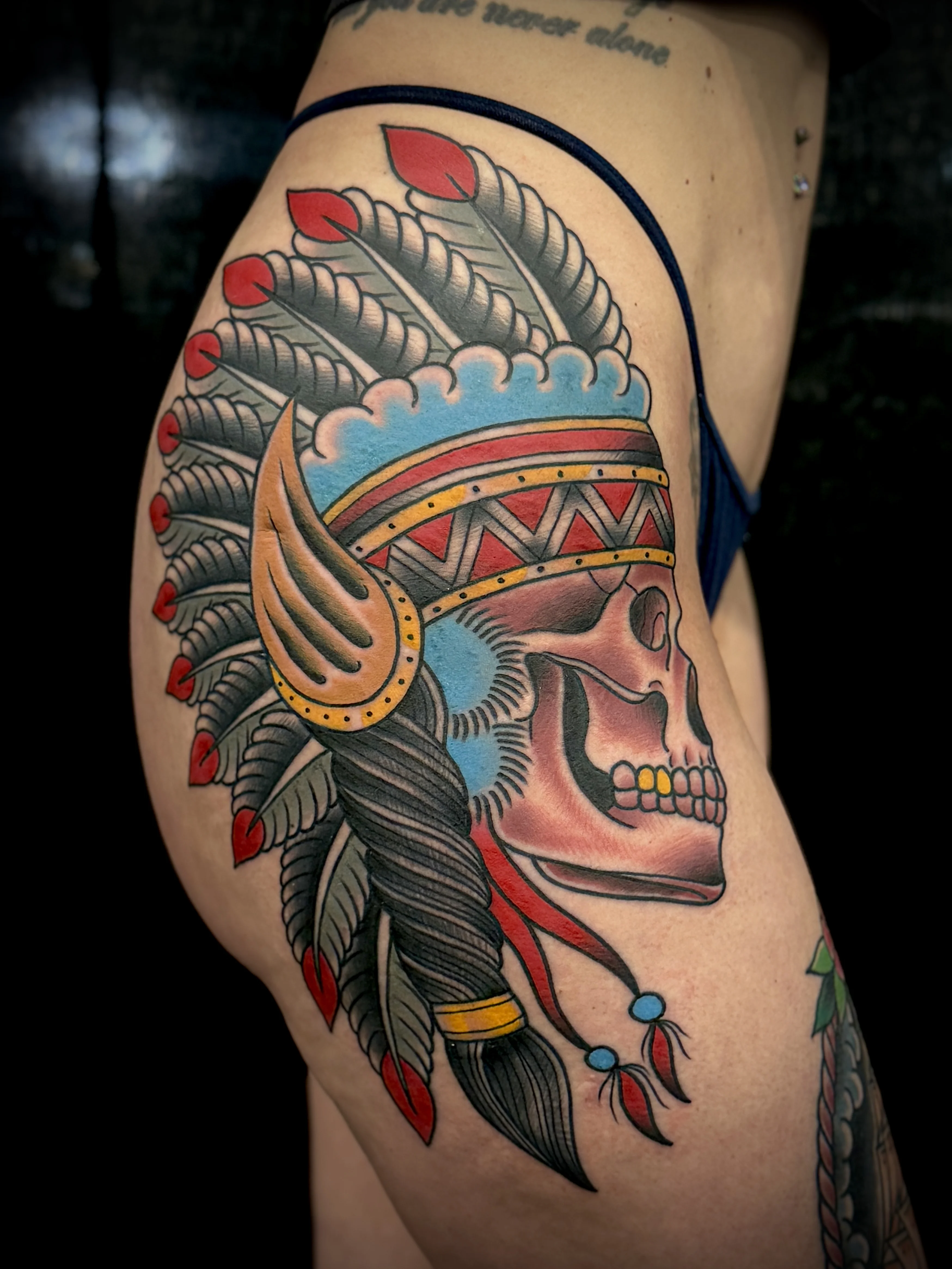 Traditional tattoo by Don Don: skull, feather headdress, feathers, braided hair