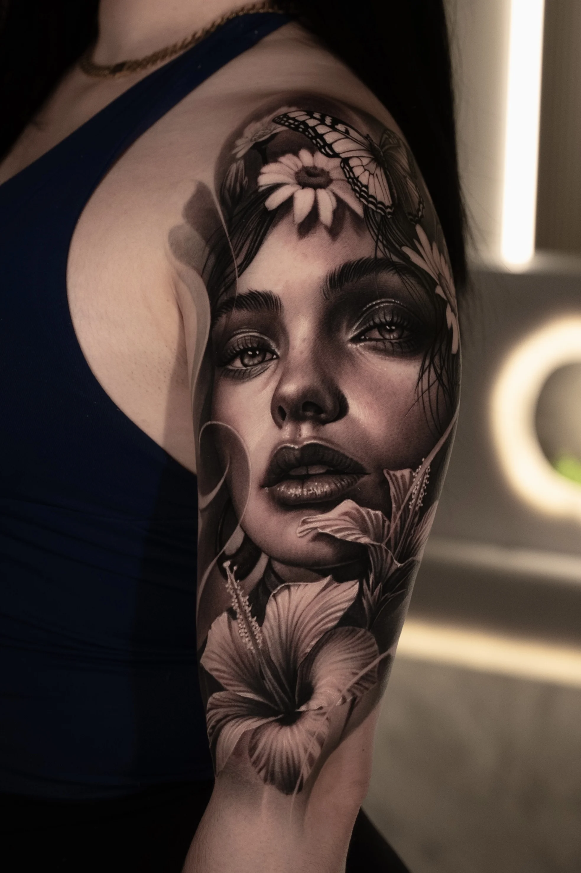 Black & Gray Realism tattoo by Gara: woman, daisy flower, butterfly, hibiscus flower