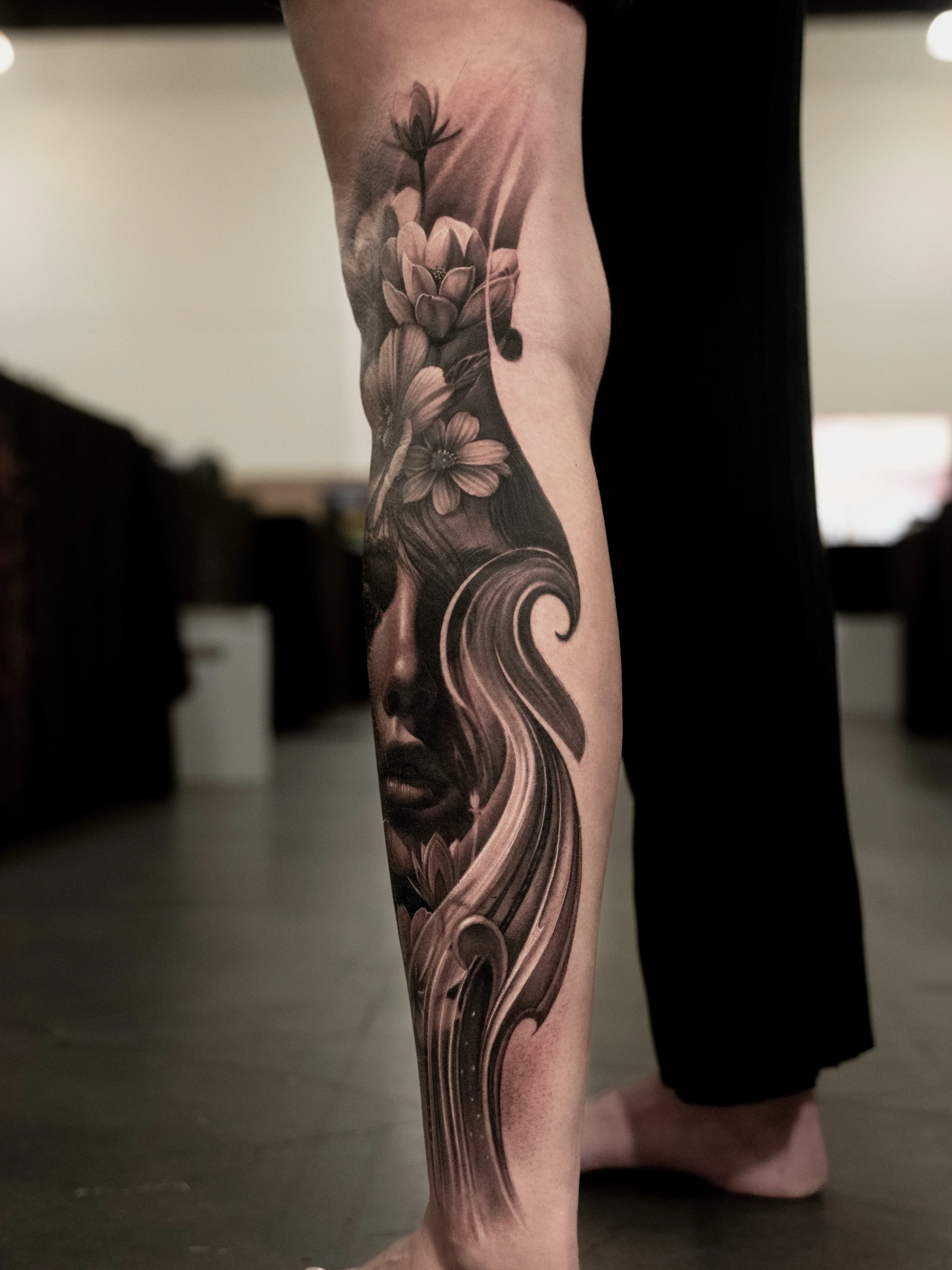 Black & Gray Realism tattoo by Gara: woman face, flowers, abstract waves, floral