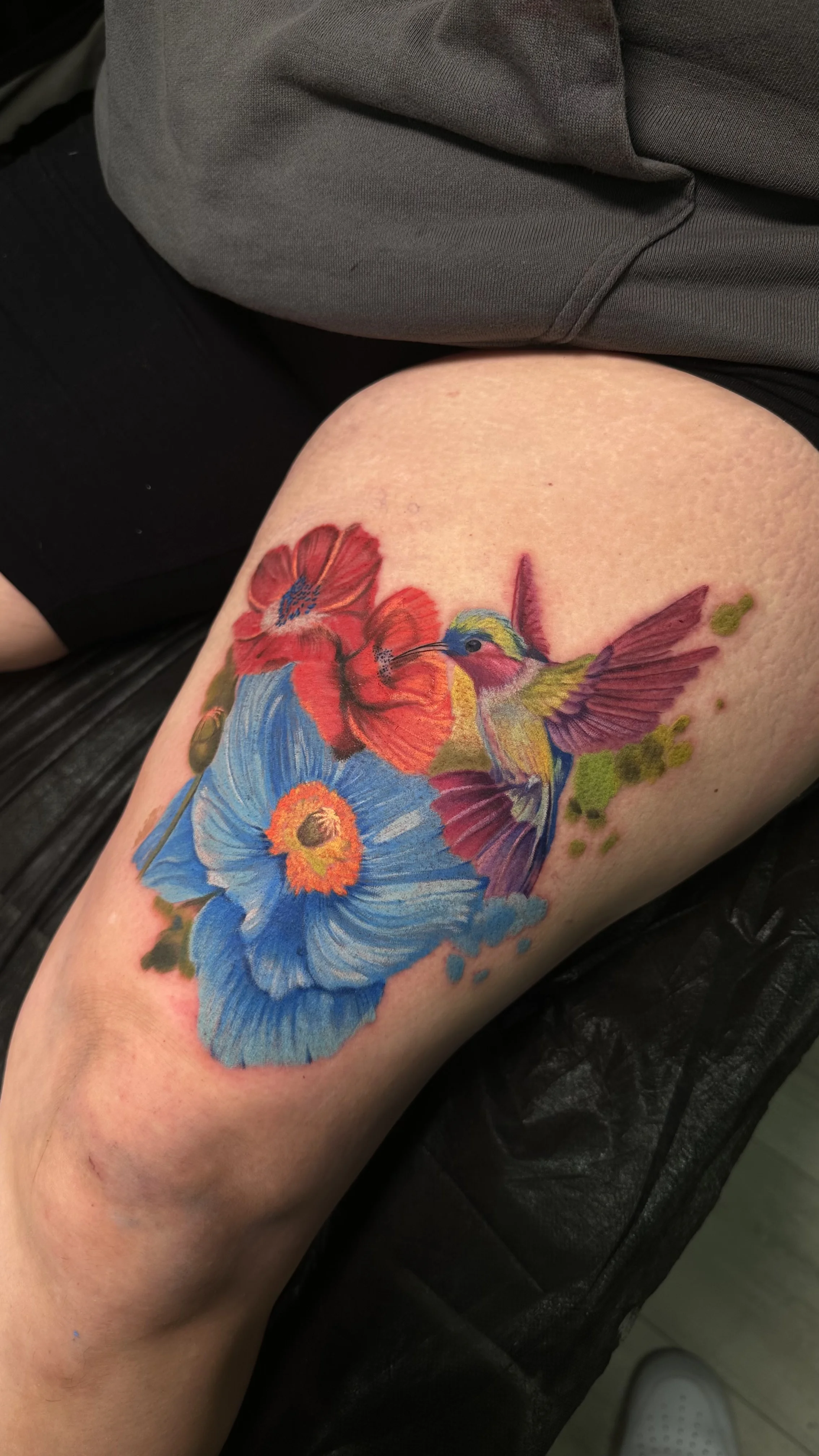 Color Realism tattoo by Ser. Alex: hummingbird, blue flower, red flower, green leaves