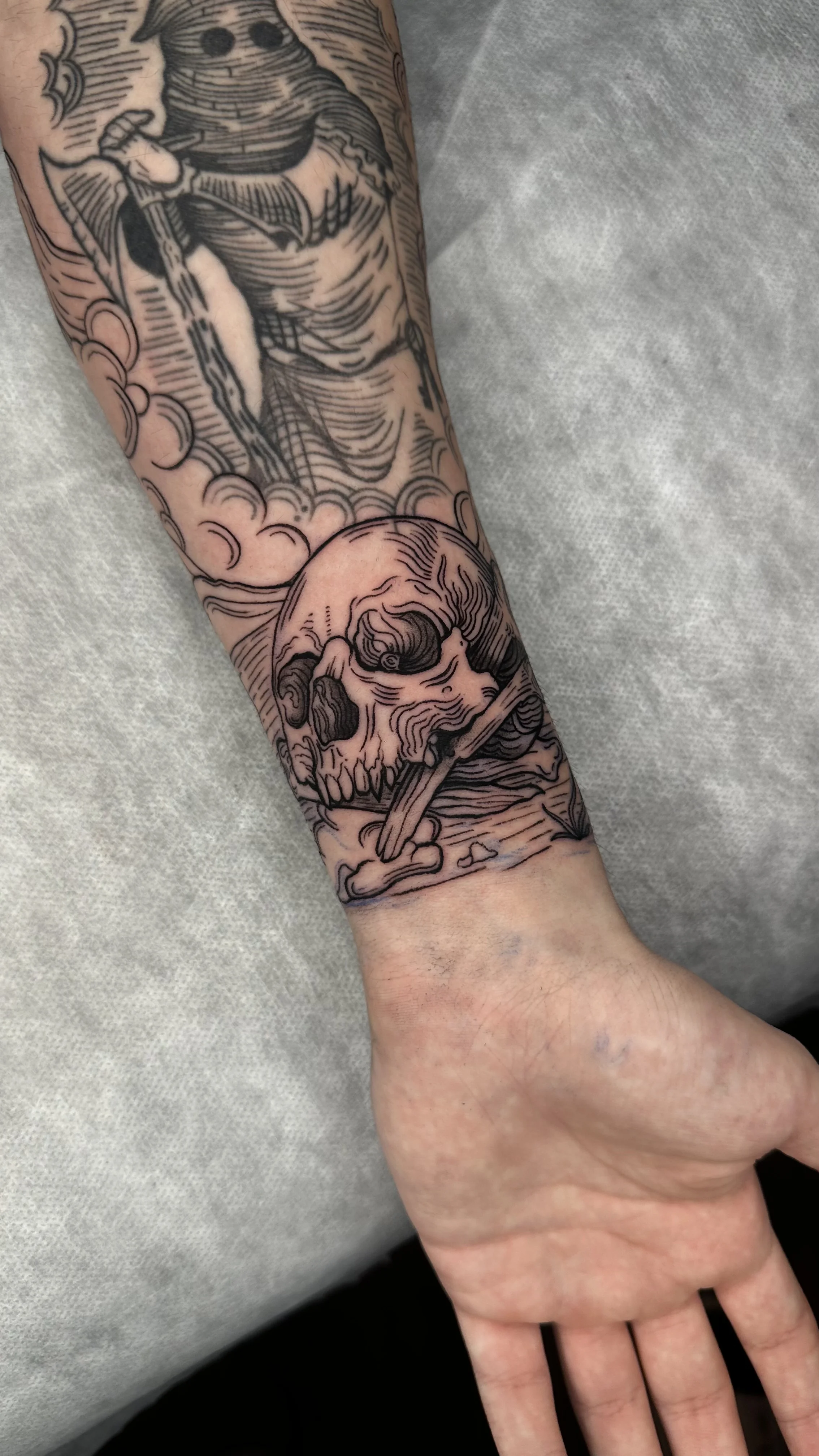 Black & Gray Realism tattoo by Ser. Alex: skull, bone, blade, clouds