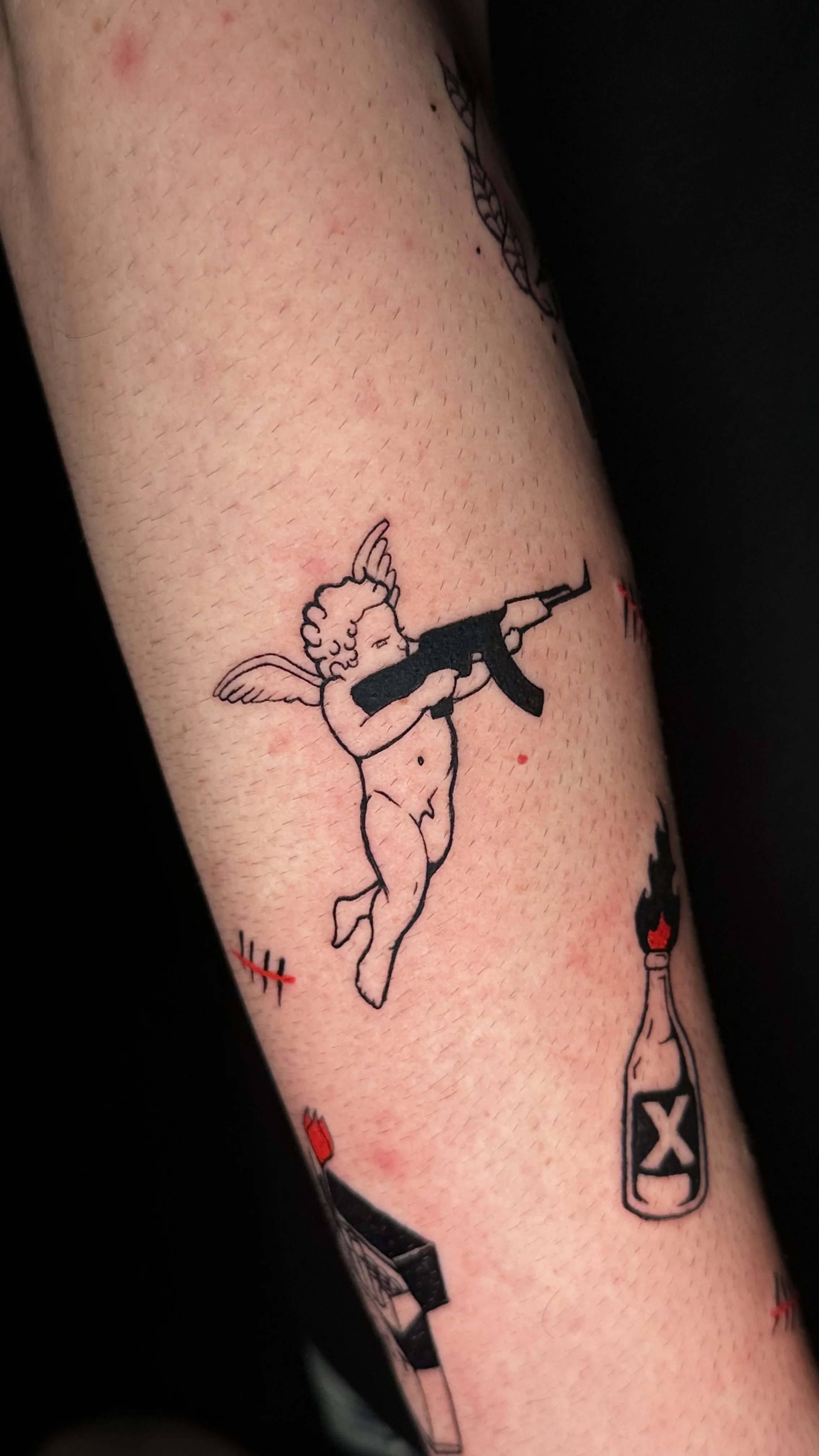 Blackwork tattoo by Ser. Alex: cherub, wings, rifle, molotov cocktail