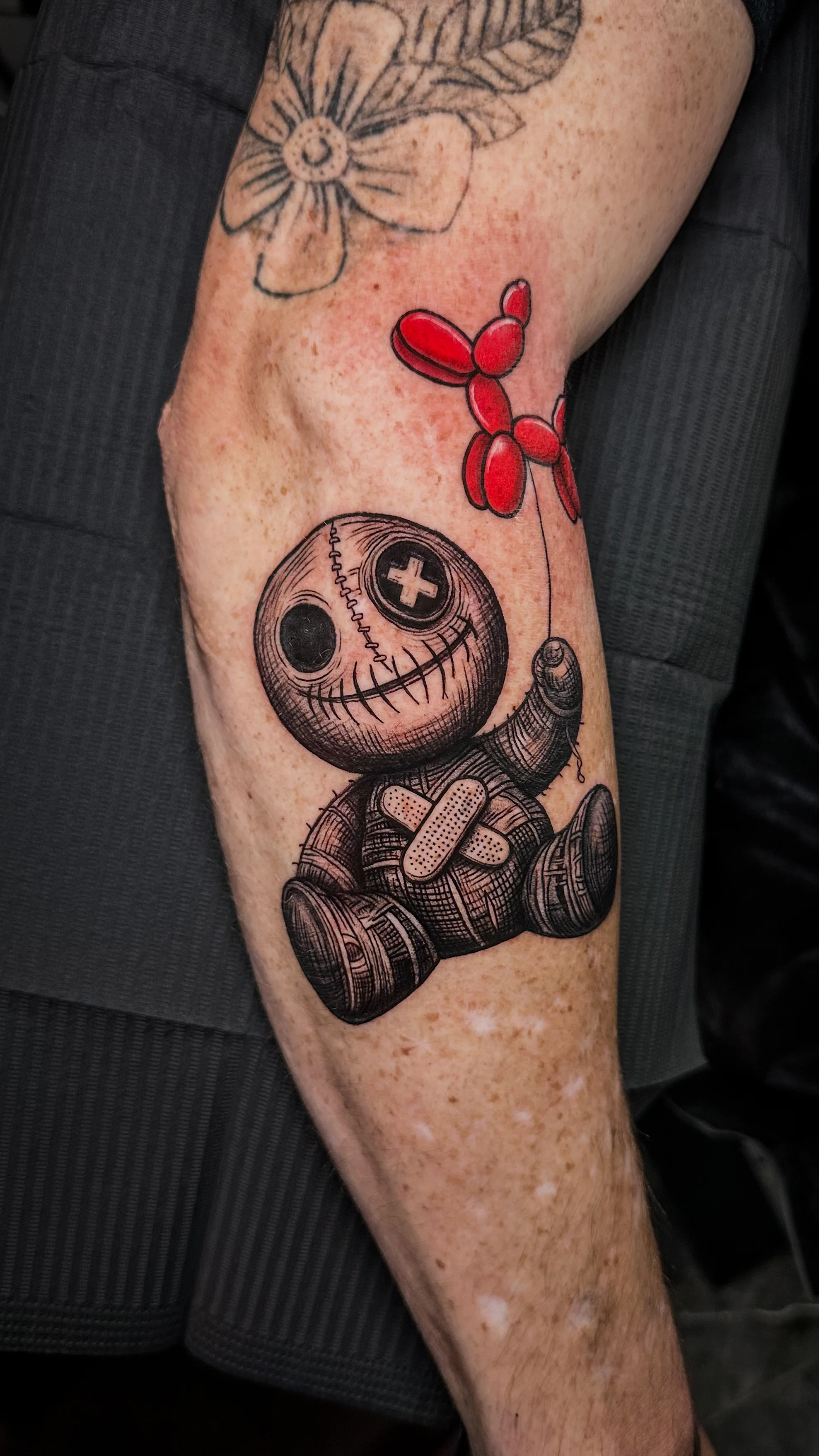 Illustrative tattoo by Ser. Alex: voodoo doll, balloon animal, flower, dark