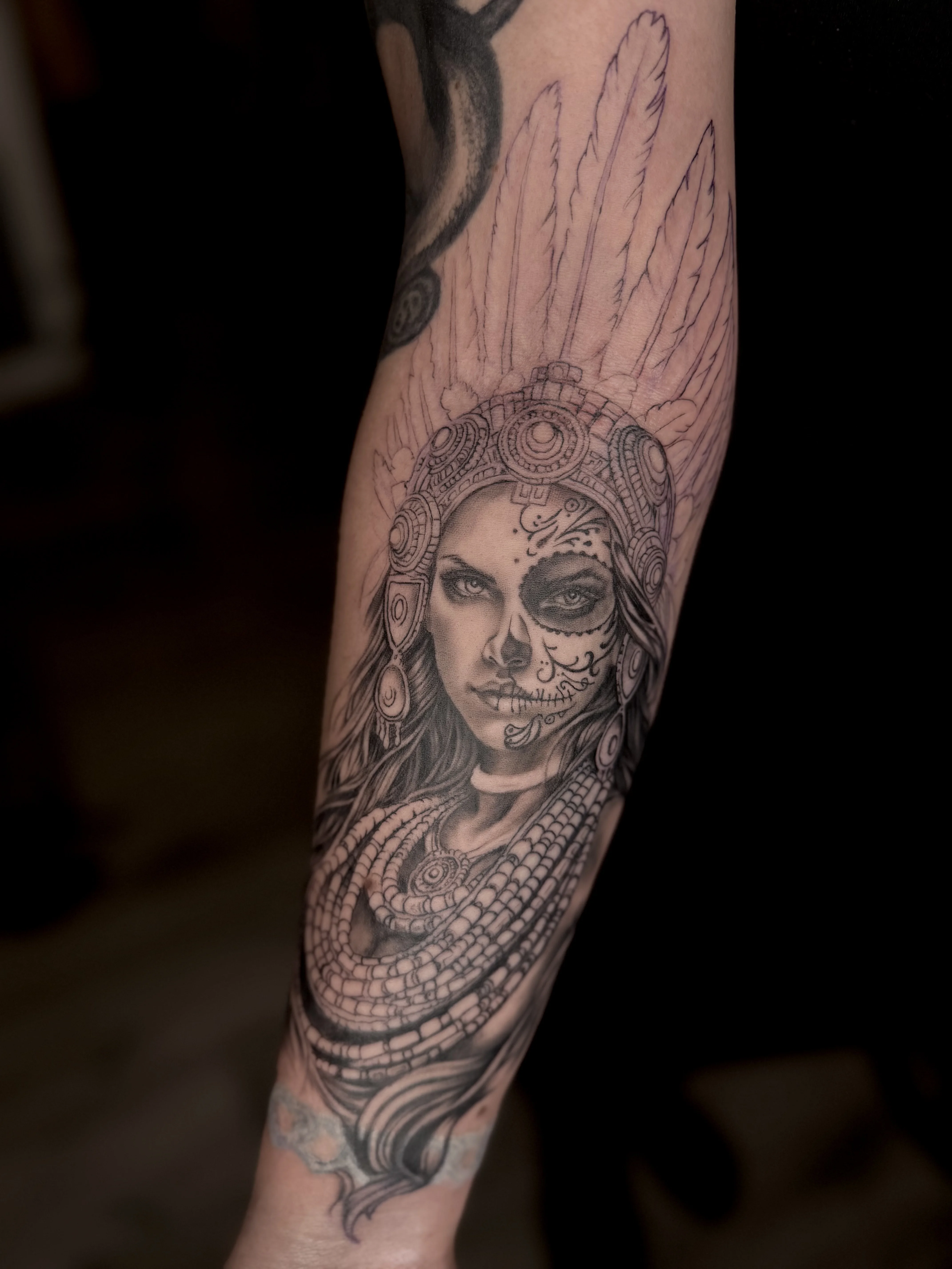 Feminine Black & Grey Aztec warrior princess wip: woman, feather headdress, skull face paint, necklace, long hair, spiritual