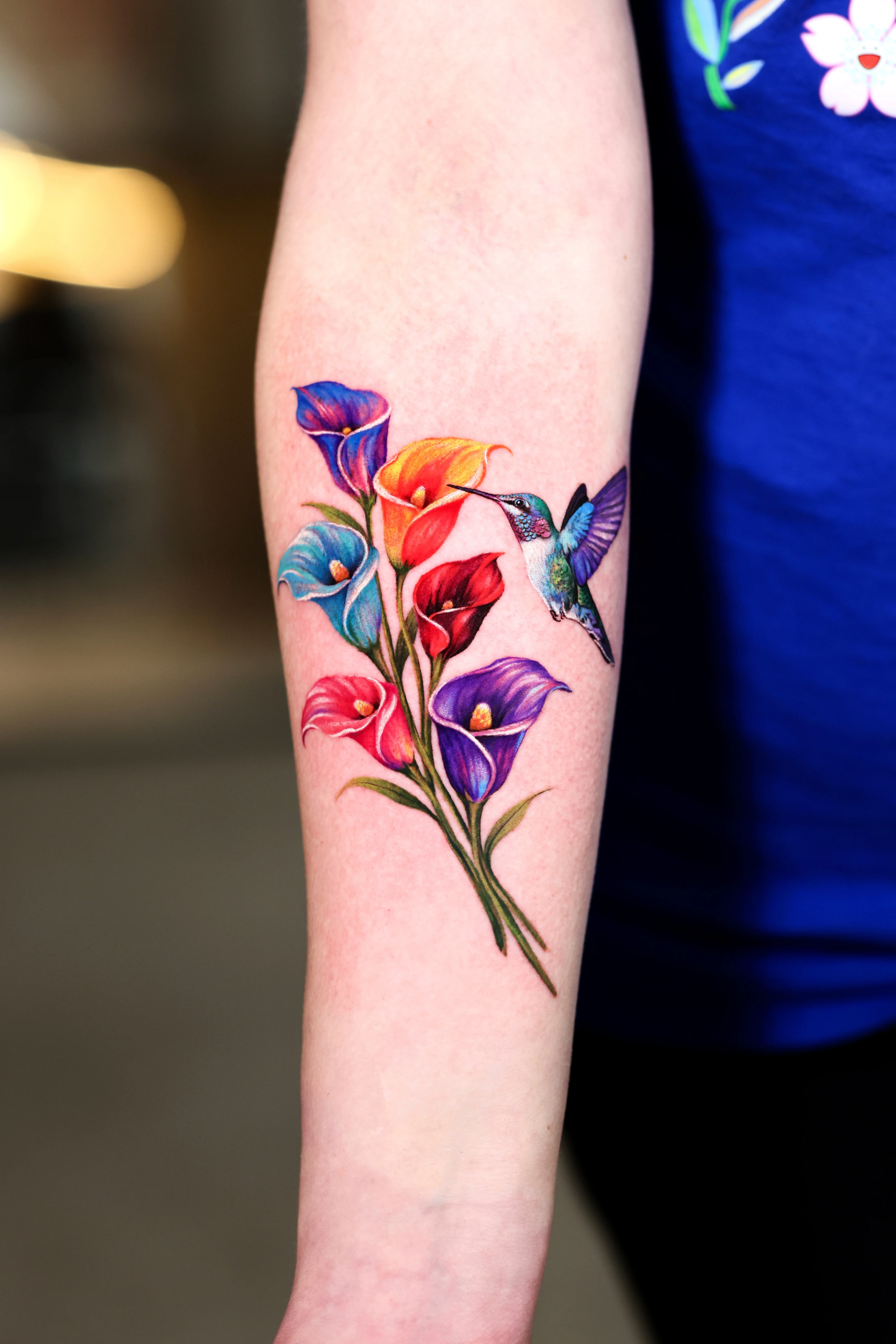 Color Realism tattoo by Dokhwa: calla lily flowers, hummingbird, floral, nature