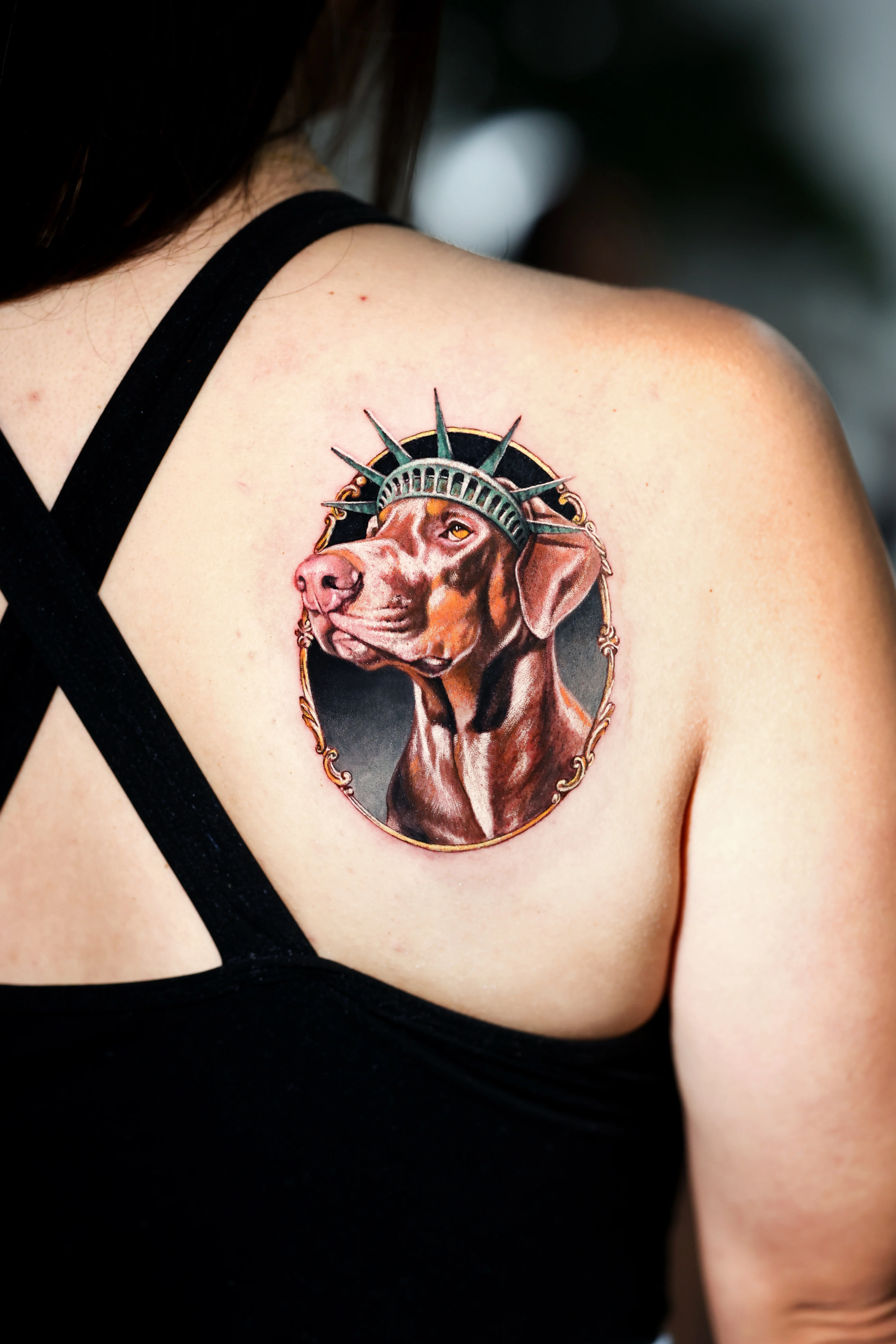 Color Realism tattoo by Dokhwa: dog, statue of liberty crown, portrait frame, animal