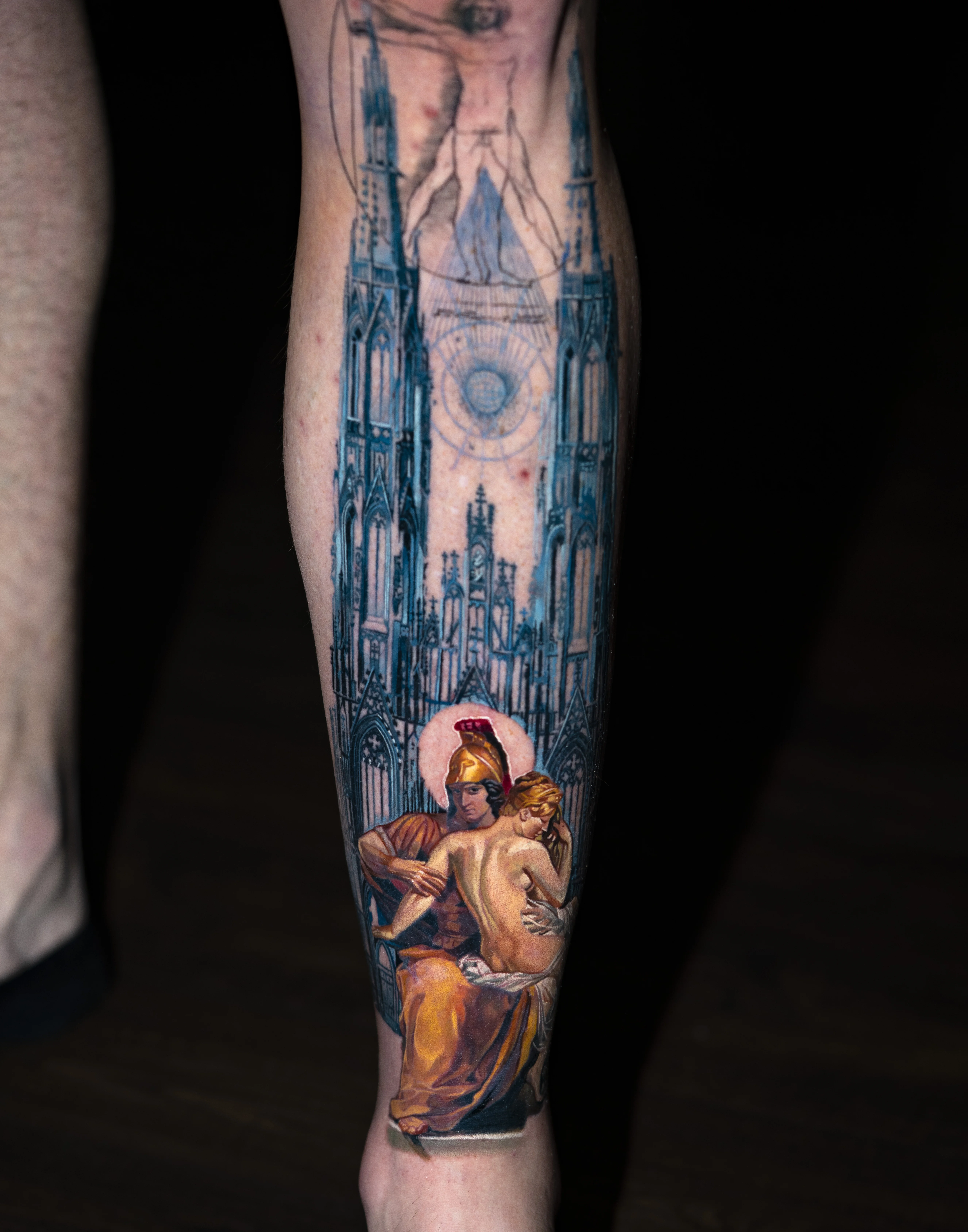 Color Realism tattoo by Q tattoo: helmeted warrior, woman, cathedral, vitruvian man