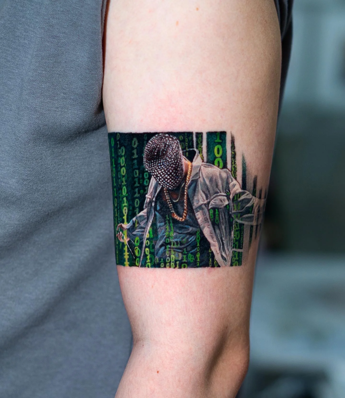 Color Realism tattoo by Q tattoo: masked person, chain necklace, jacket, binary code