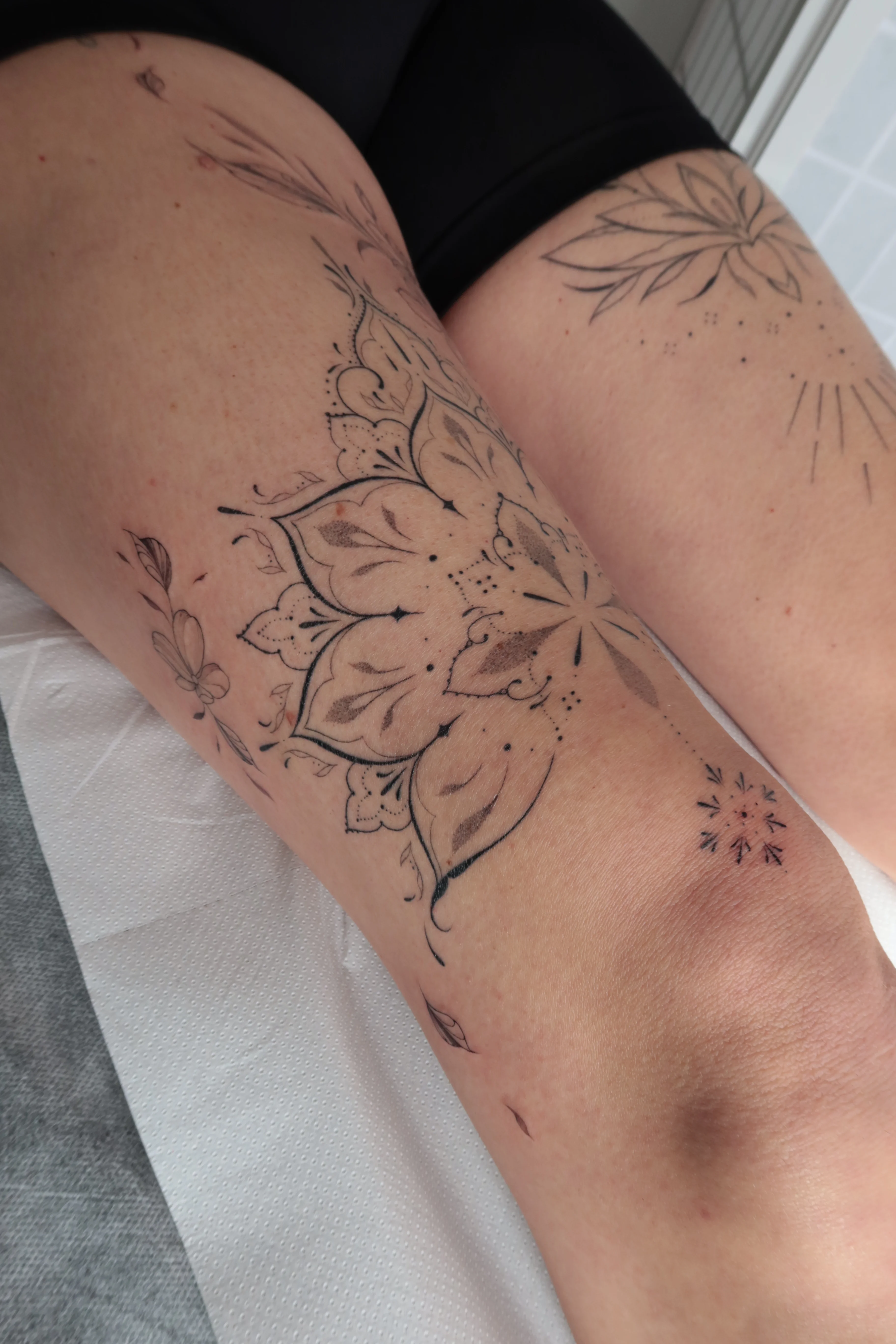 Fine Line tattoo by Abigail Louise: mandala, flower, petals, dotwork