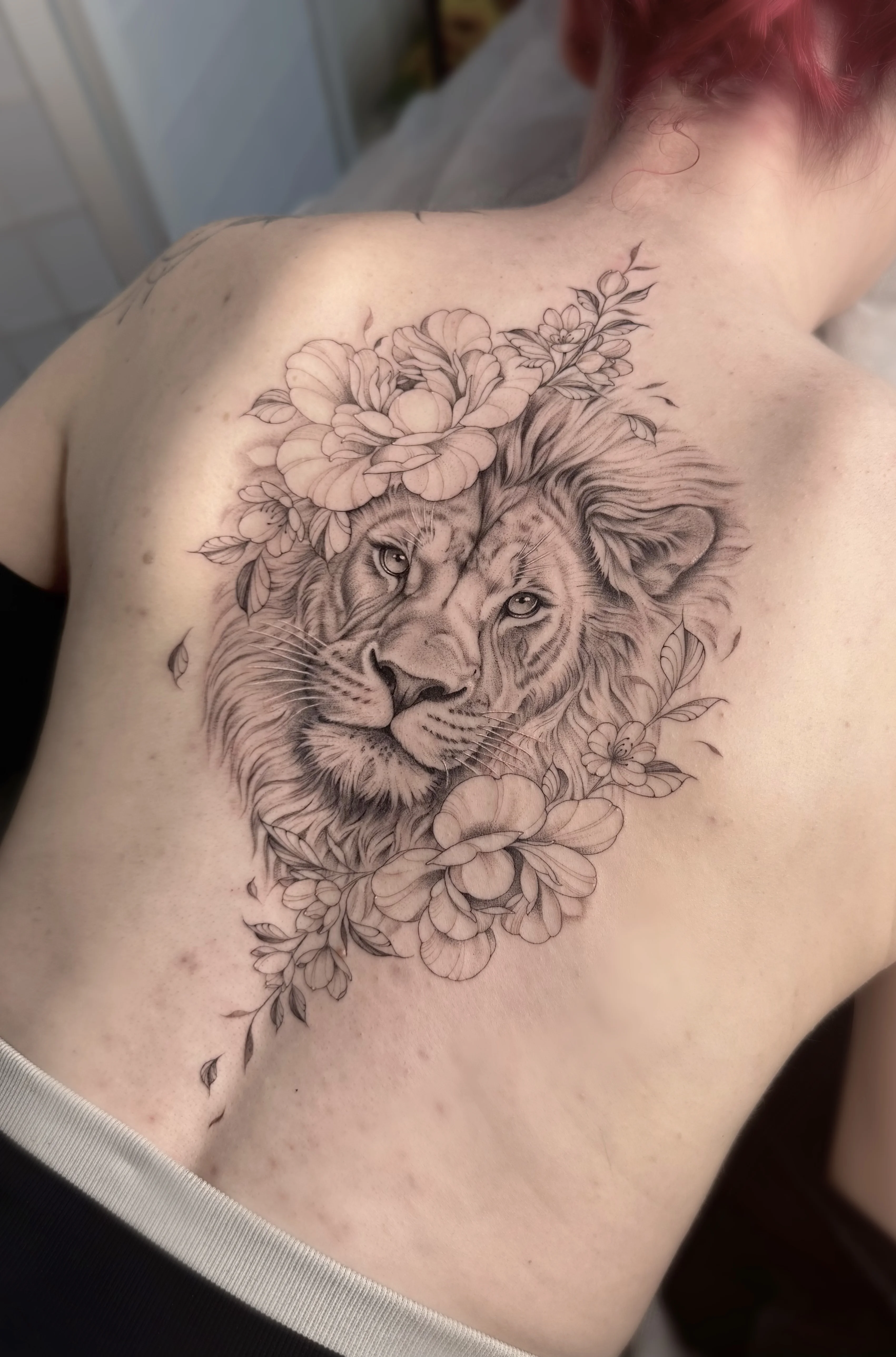 Black & Gray Realism tattoo by Abigail Louise: lion, flowers, leaves, animal